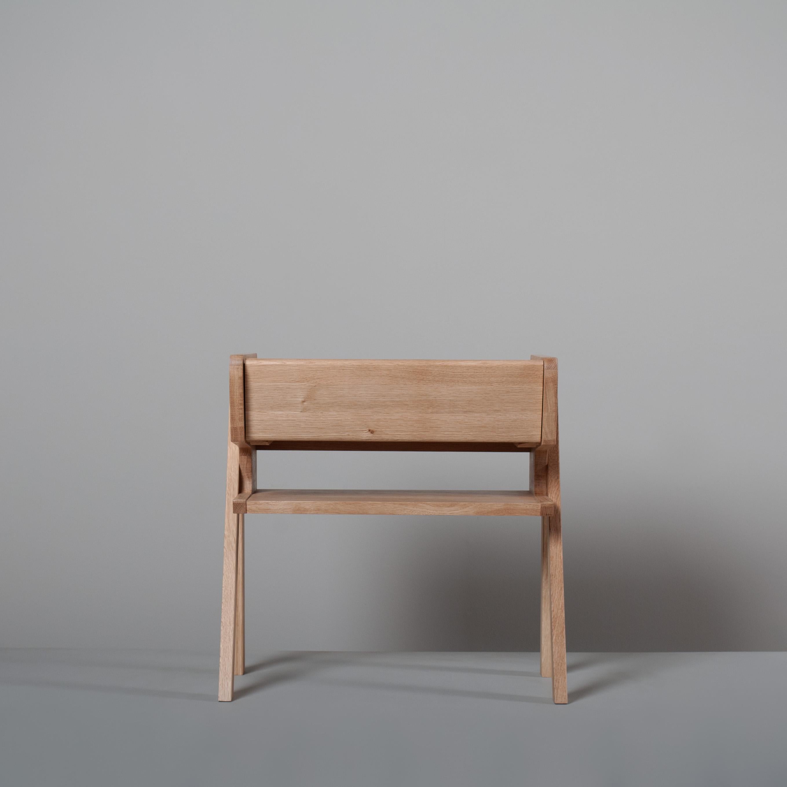 Hand-crafted European Oak night stand of modernist design. Top user surface with one slide out drawer and midway shelf. A design drawing upon Scandinavian and European mid century influence and style. Handmade in London. Made to order. 