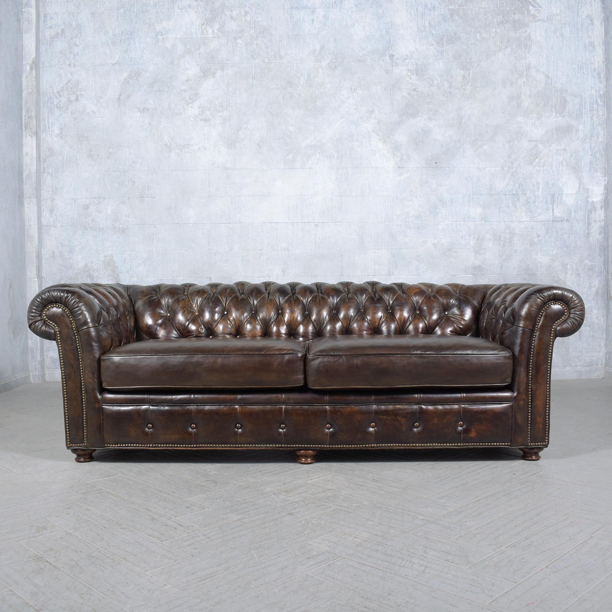 Experience the grandeur of our vintage 1970s Chesterfield sofa, a paragon of classic luxury and meticulous craftsmanship. Hand-crafted from solid wood and sumptuous leather, this sofa has been rejuvenated by our adept craftsmen to showcase a rich