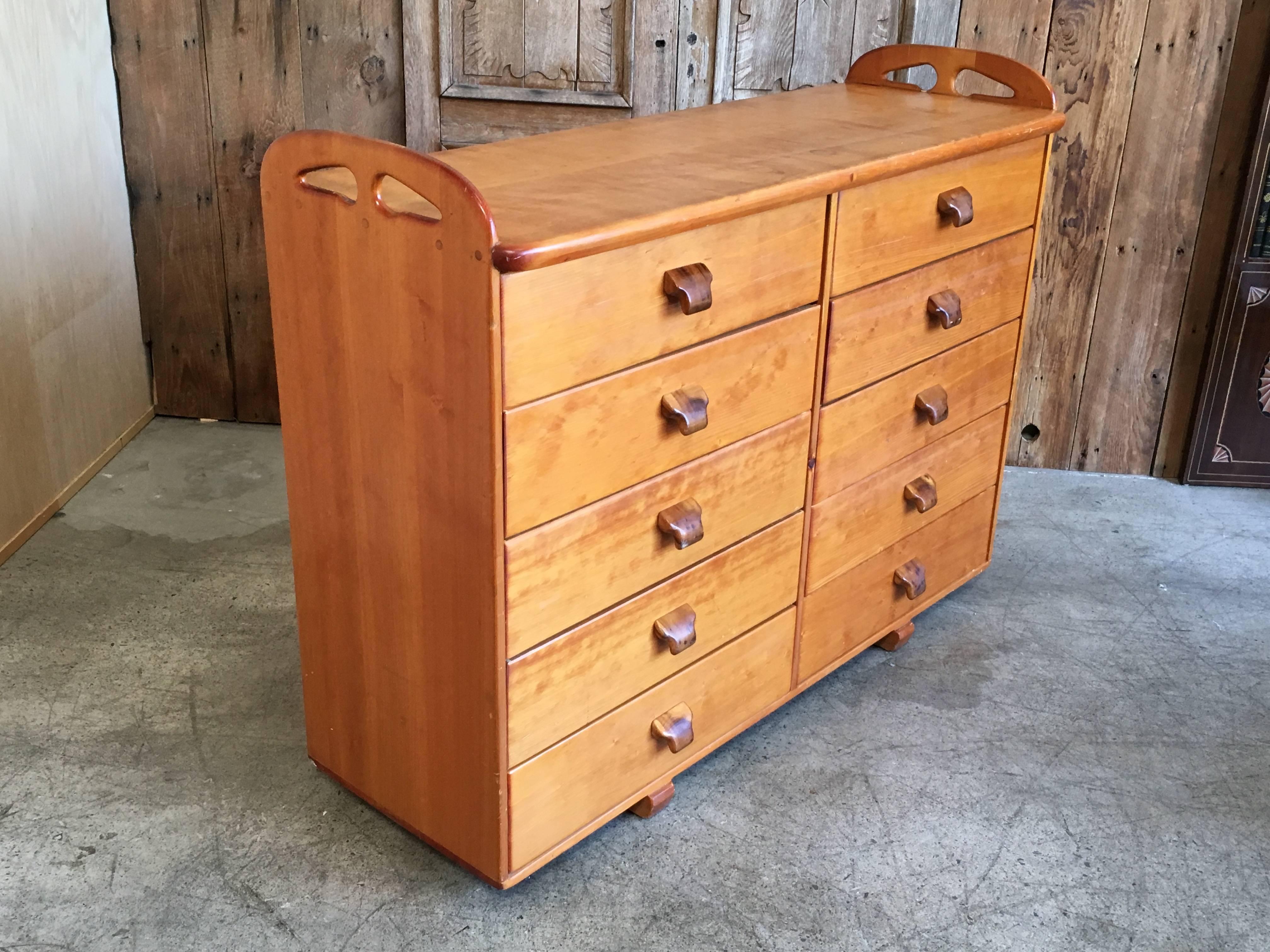 1970s ten-drawer dresser made of pine with koa wood handles with lots of storage it has a hippie coastal look.