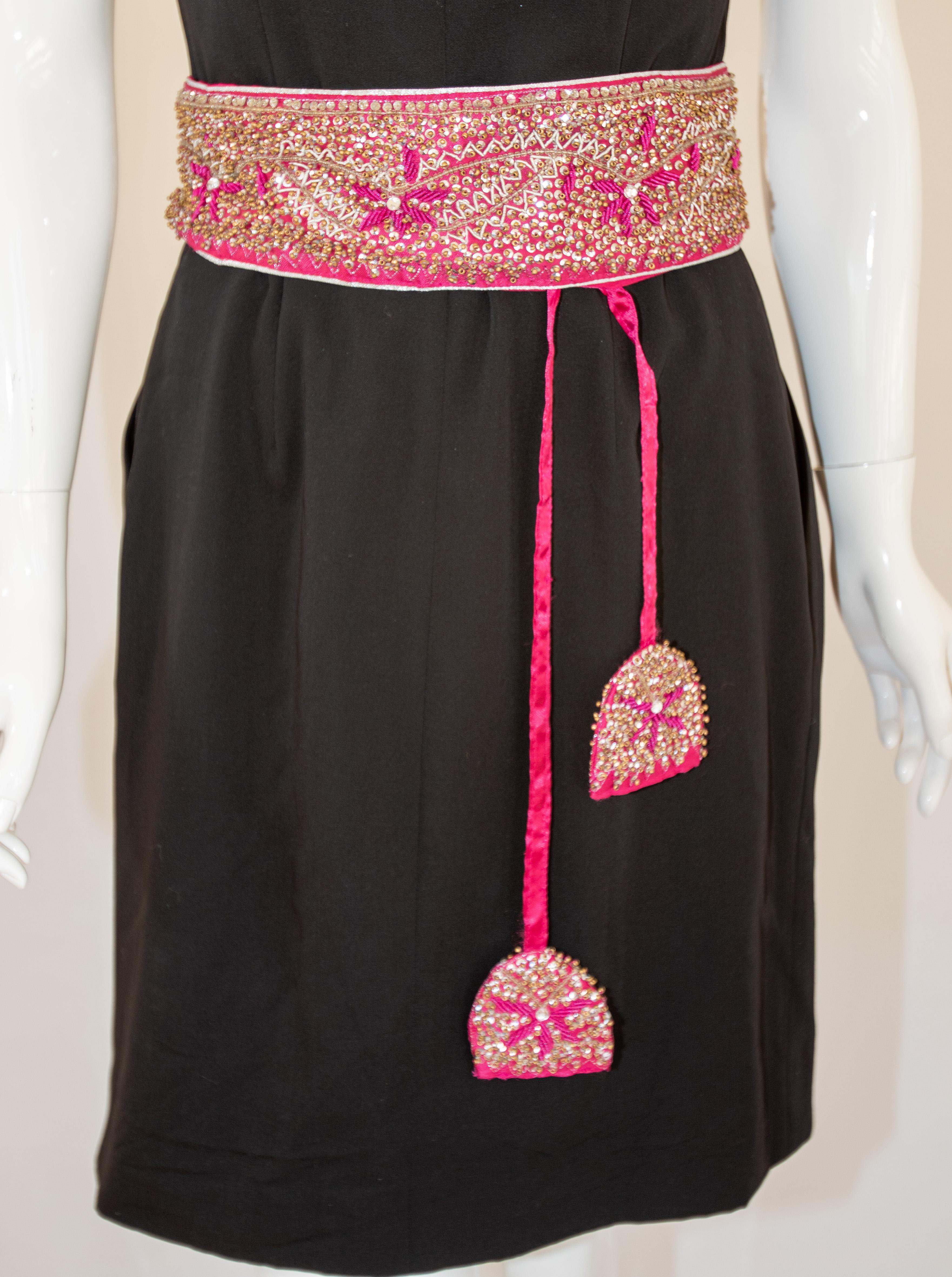 Grace your waistline with this saree embroidery Bohemian fuchsia pink belt. 
This hot pink belt is designed to give a very stylish bohemian look for your outfit.
Handcrafted maggam work waist belt embroidered on silk cloth.
Material: Silk Brocade