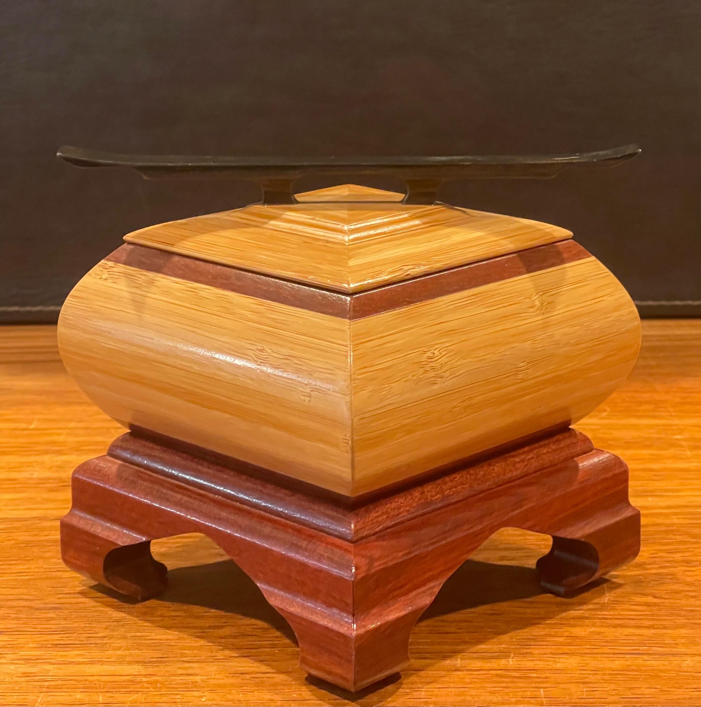 A unique post-modern mixed woods jewelry box handcrafted and signed by the artist, circa 2006. The box is a mix of mahogany, oak, cherry and ebony woods. Elegant design and styling.  
The box is in very good condition and measures 6