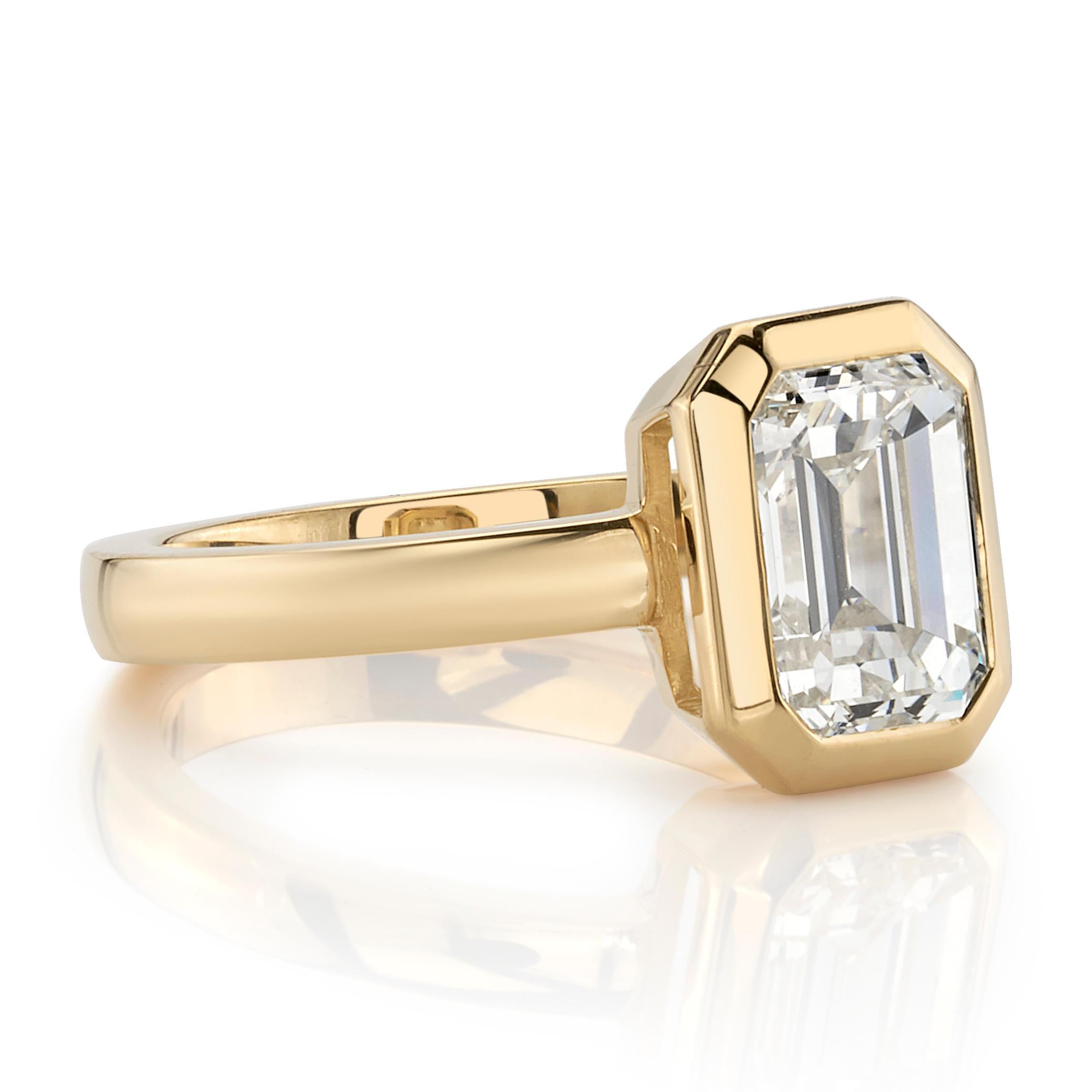 2.03ct N/VS1 GIA certified emerald cut diamond bezel set in a handcrafted 18K yellow gold mounting.