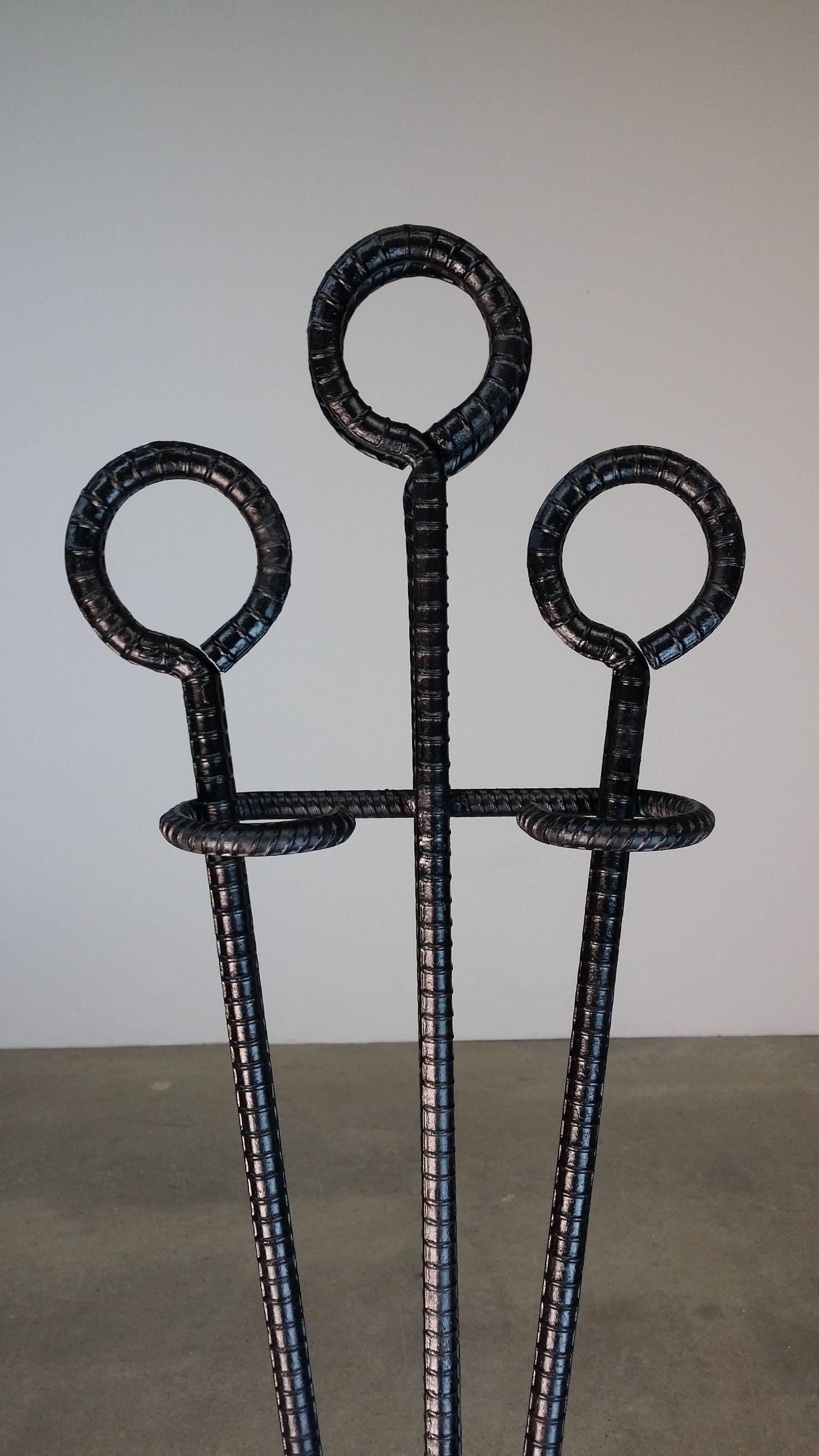 Handcrafted fire tool set, made by a blacksmith, circa 1970. Set has been refinished in black enamel, and the brush has been replaced. Stands 40 3/4