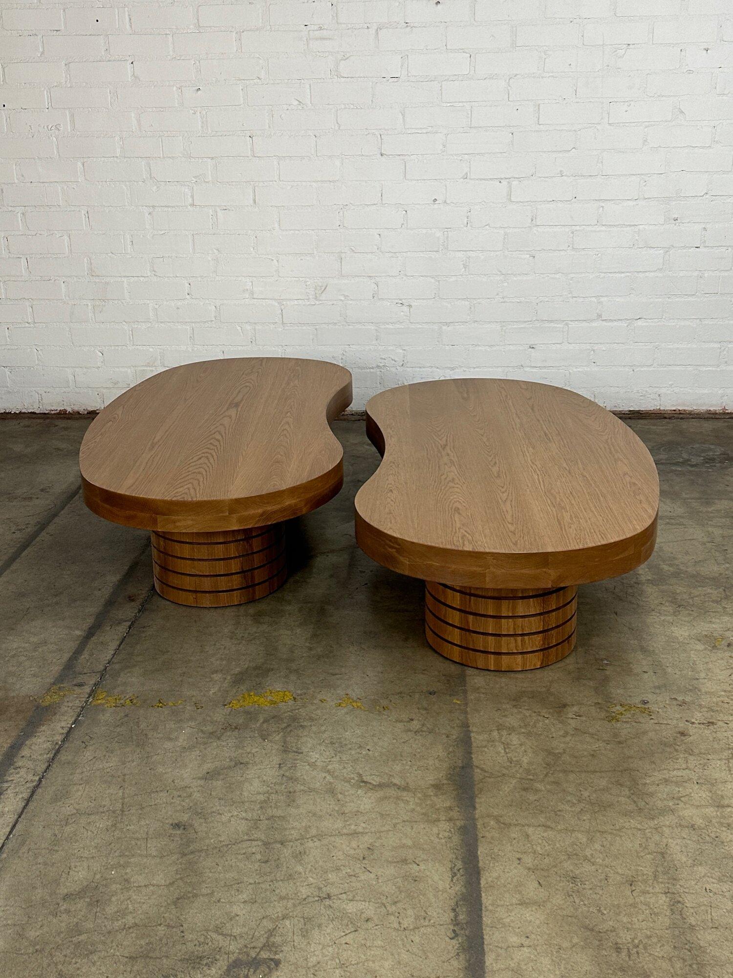 W64 D31 D30 H15.5

Handcrafted free hand coffee tables in solid white oak. These features hand drawn surfaces patterns. Tables have heavy and thick three half inch surfaces. Tables sit on solid oak ribbed cyclindrical bases hand turned in house.