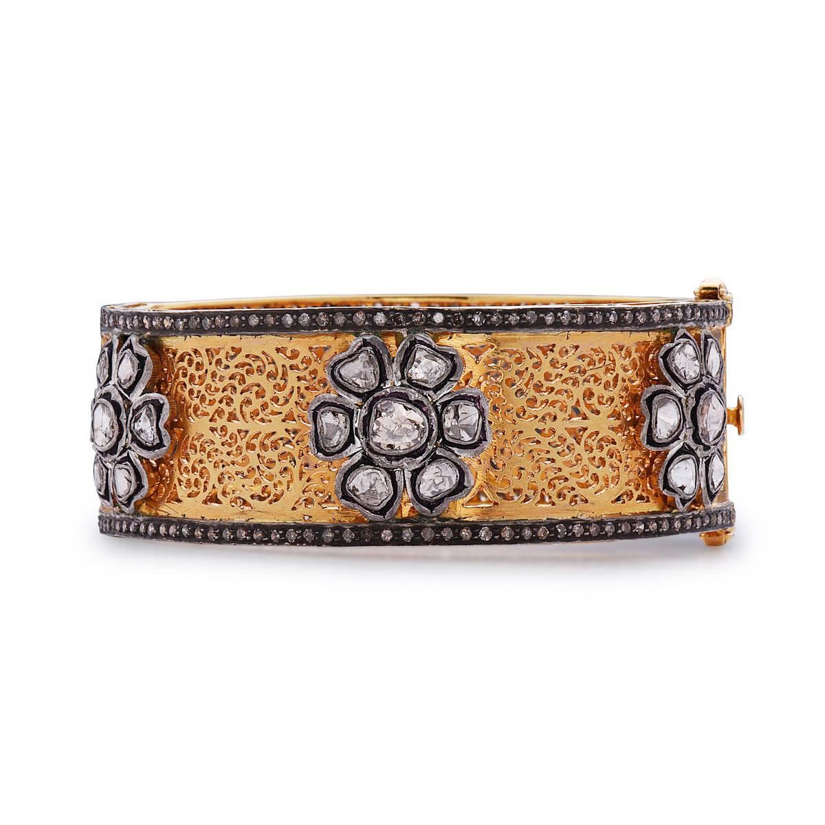 This very intricately handcarved 14K yellow gold bangle is perfect bangle to go with any attire and make you feel very special with beautiful floral patter all around the bangle.This bangle is openable with 2 safety clasps and fits very well.
