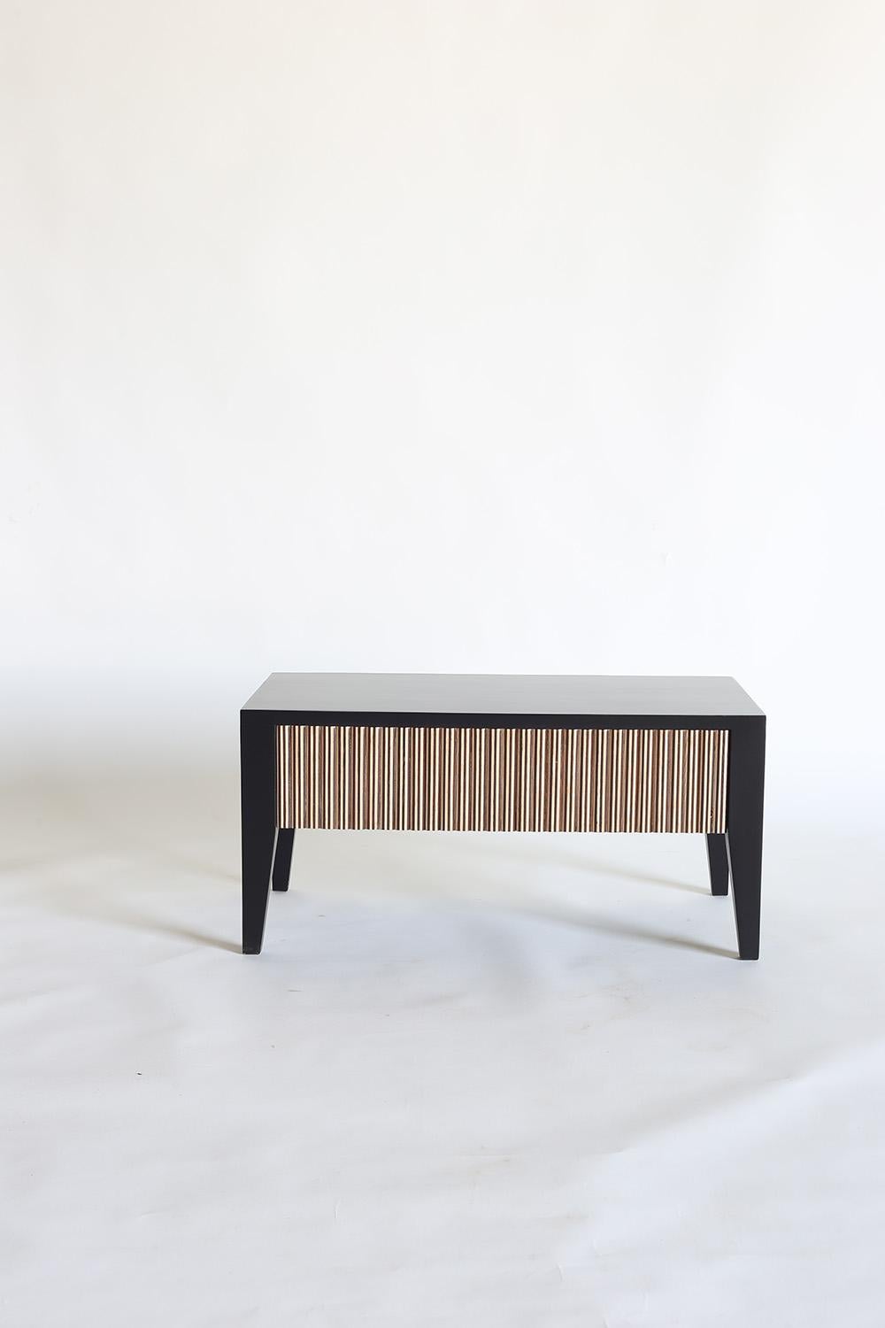 Bringing an air of calm and artistic beauty into the home, the Saral Side Table is an exquisitely handcrafted piece. Using white oak, it features delicate inlaid woodwork that forms a repeating pattern across each facade. The subtle styling of the