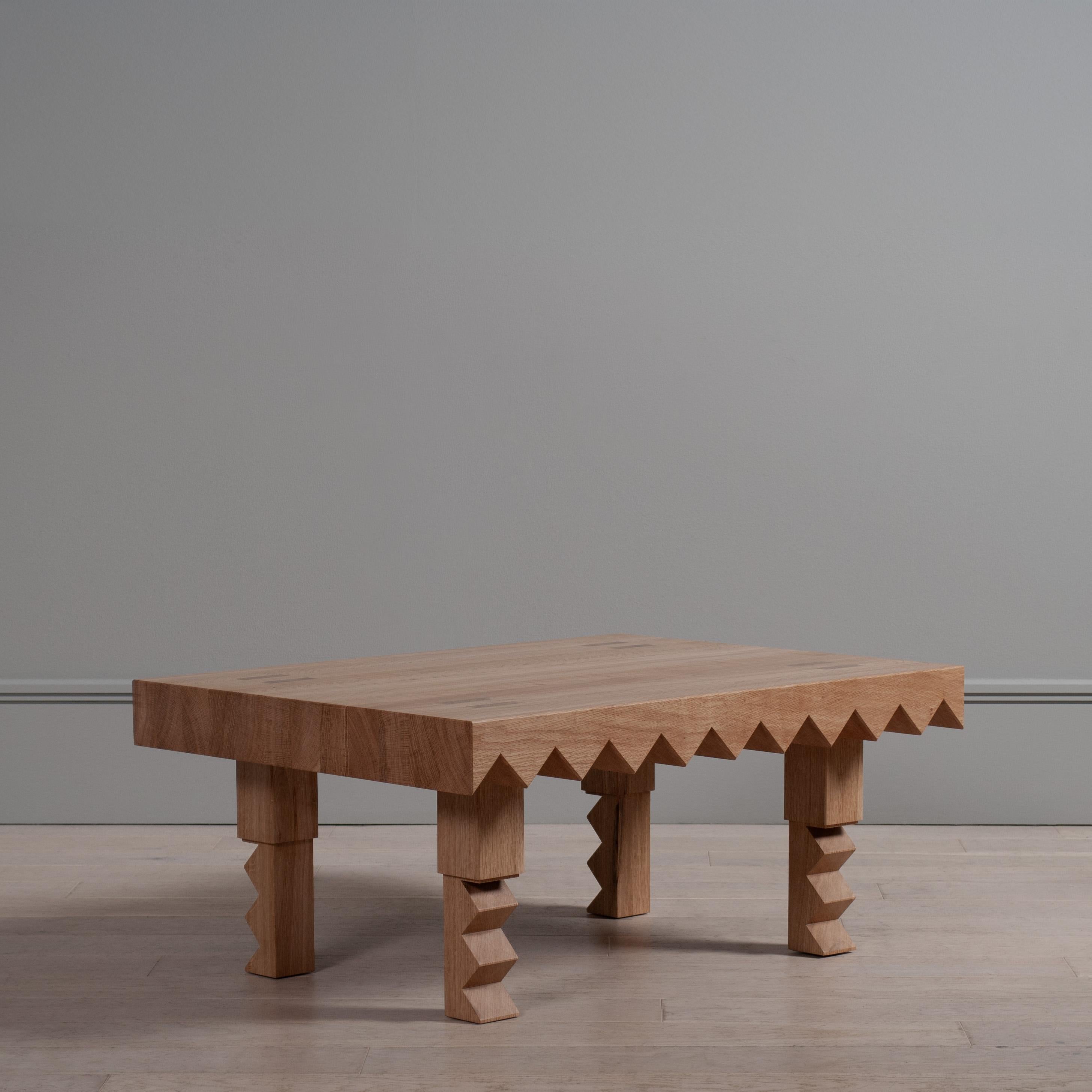 Table basse en dents de scie en chêne anglais massif. Un design extrêmement audacieux et robuste, qui se caractérise par des assemblages à tenons et mortaises calés, taillés avec précision à la main.

Le design s'inspire d'un large éventail de