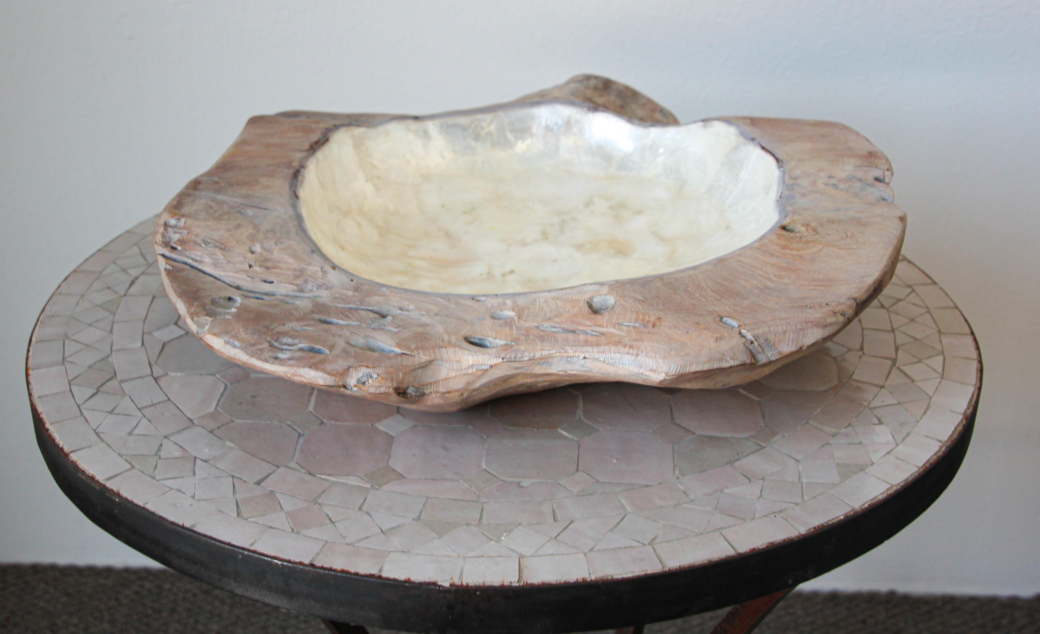 Exceptionally crafted and large sculptural brutalist freeform teak wood centerpiece bowl.
Hand carved from a unique piece of wood this organic capiz bowl is crafted of natural whitewashed teakwood and lined with lustrous authentic capiz