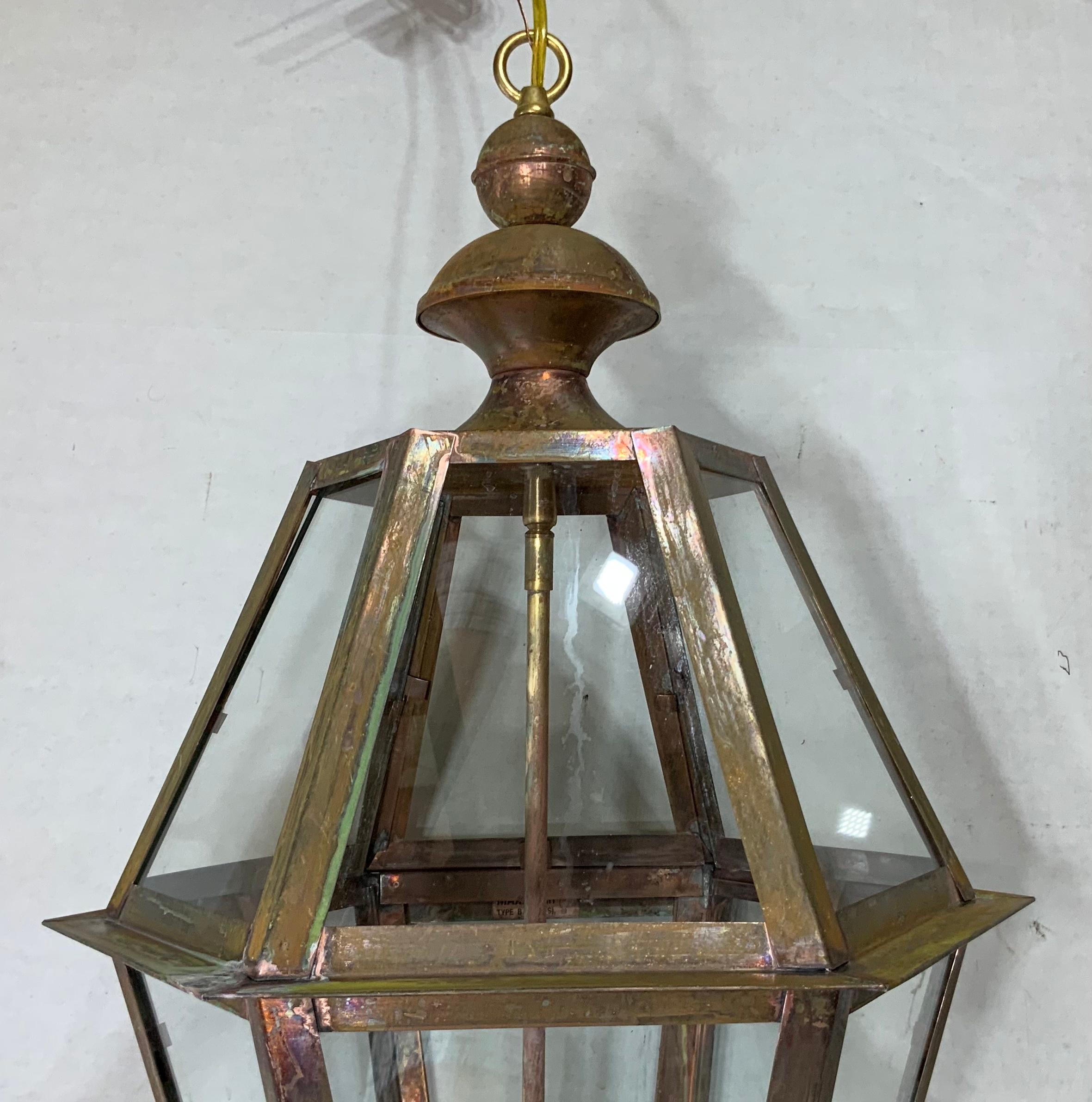 Exceptional six side hanging lantern made of handcrafted solid copper and brass stem with four 60/watt lights, weathered patina, suitable for wet location
Up to US code, UL approved, great look indoor outdoor. Copper canopy and chain included.