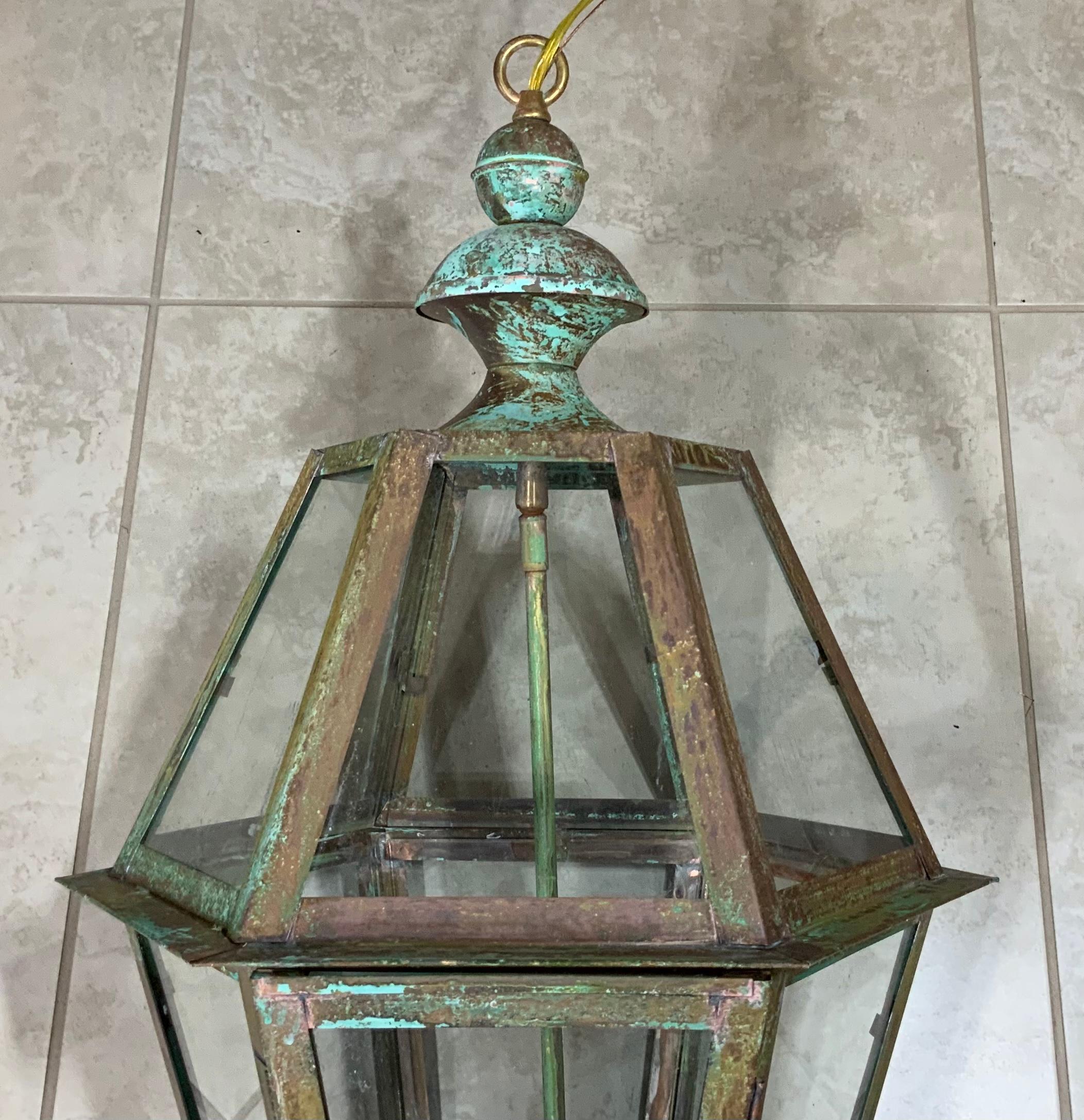 Exceptional six side hanging lantern made of handcrafted solid copper and brass stem with four 60/watt lights, weathered patina, suitable for wet location
Up to US code, UL approved, great look indoor outdoor. Copper canopy and chain included.