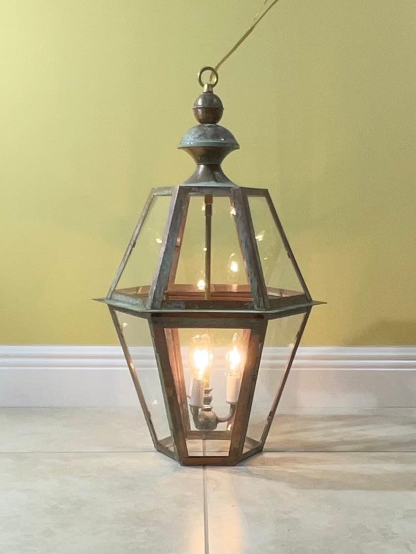 Exceptional six sides hanging lantern made of handcrafted solid copper and brass stem with three 60/watt lights, suitable for wet location
great look indoor outdoor. 
canopy and chain included.