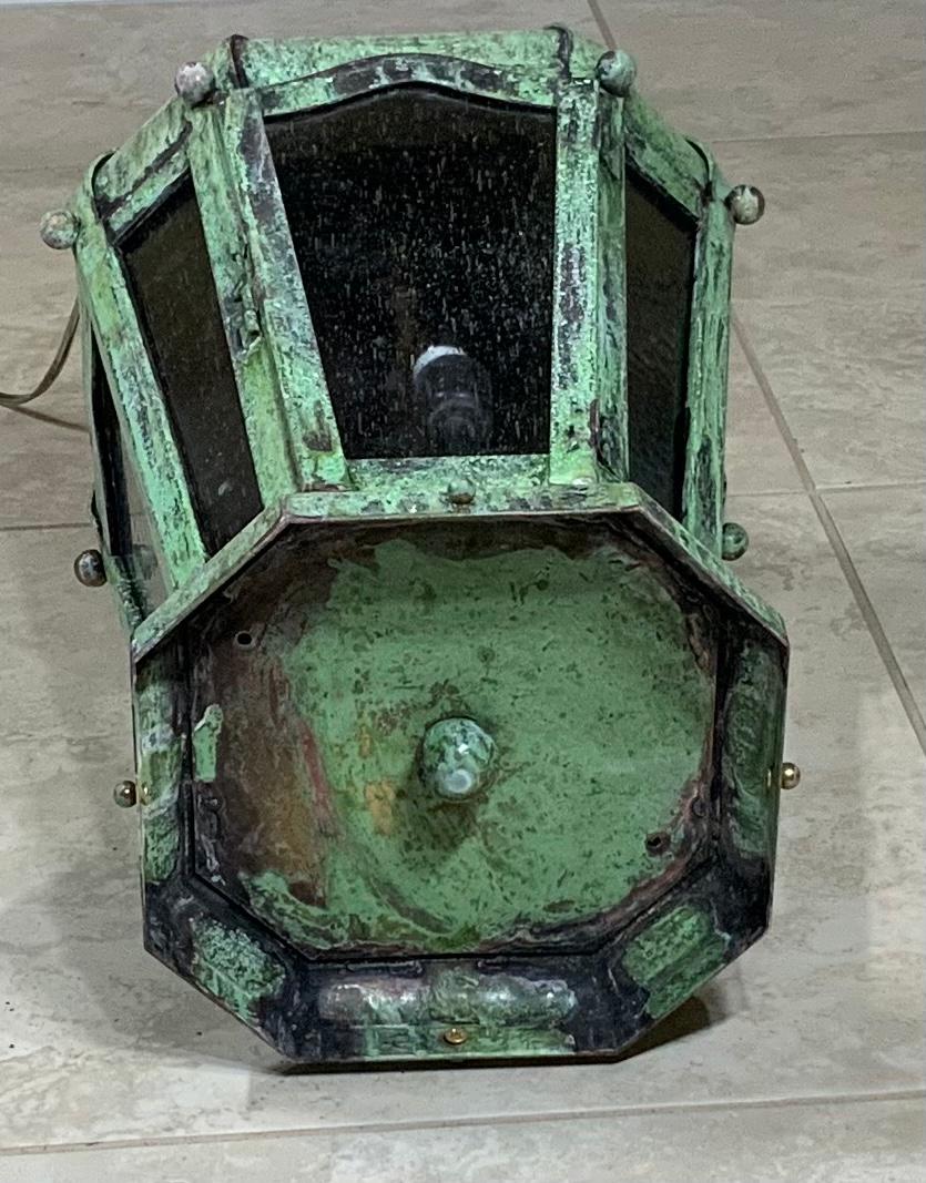 Beautiful hanging ceiling lantern in crown style top, made of solid brass. Quality handcrafted, with seeded glass. Electrified with three 40/watt lights, suitable for wet locations, ready to use. Great patina.
Will look great indoor or outdoor.