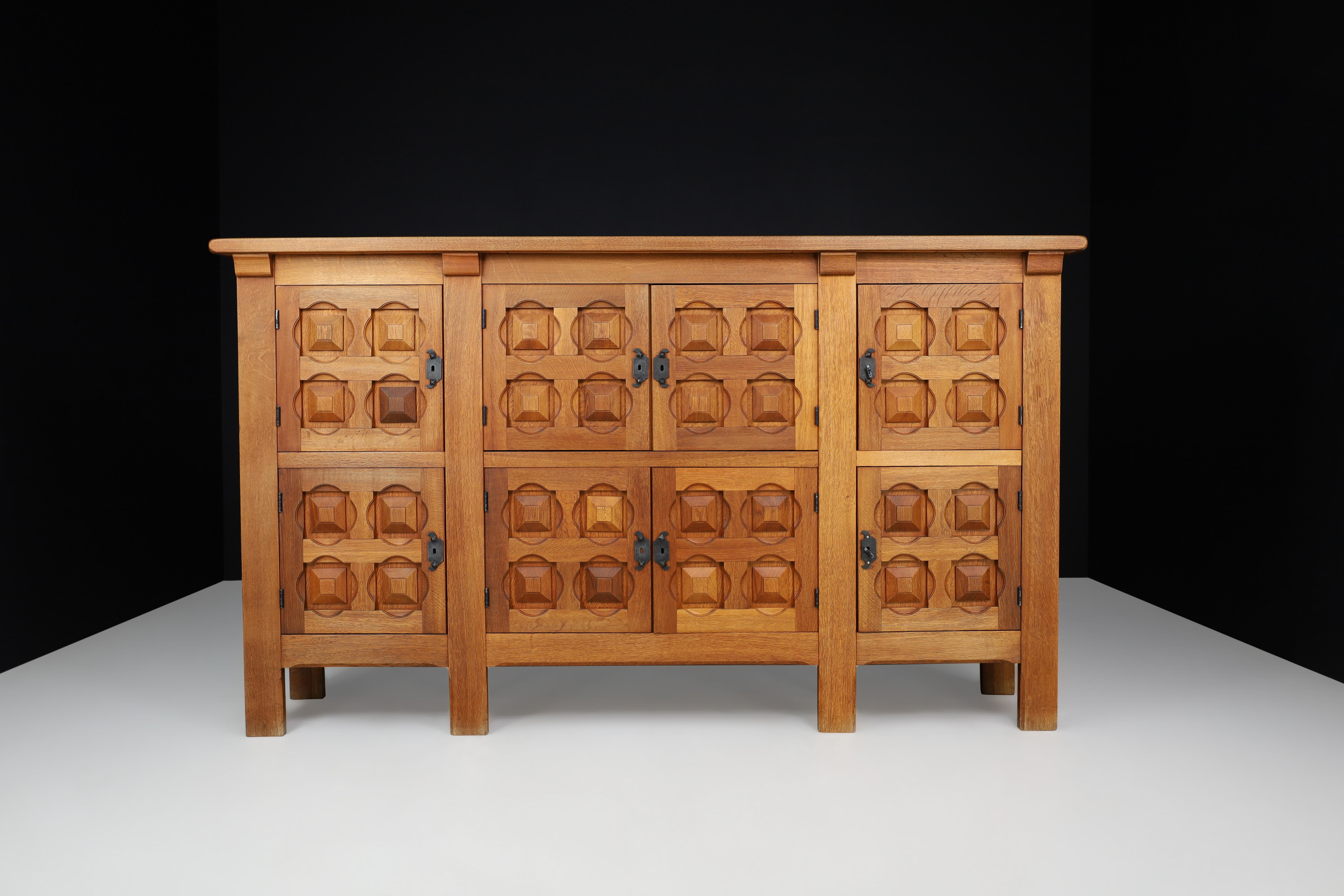 Handcrafted solid oak Credenza with wrought iron details Spain 1940s

This is a beautiful, handcrafted solid oak credenza or sideboard with wrought iron details from Spain in the 1940s. The piece has an asymmetrical structure with eight oak door