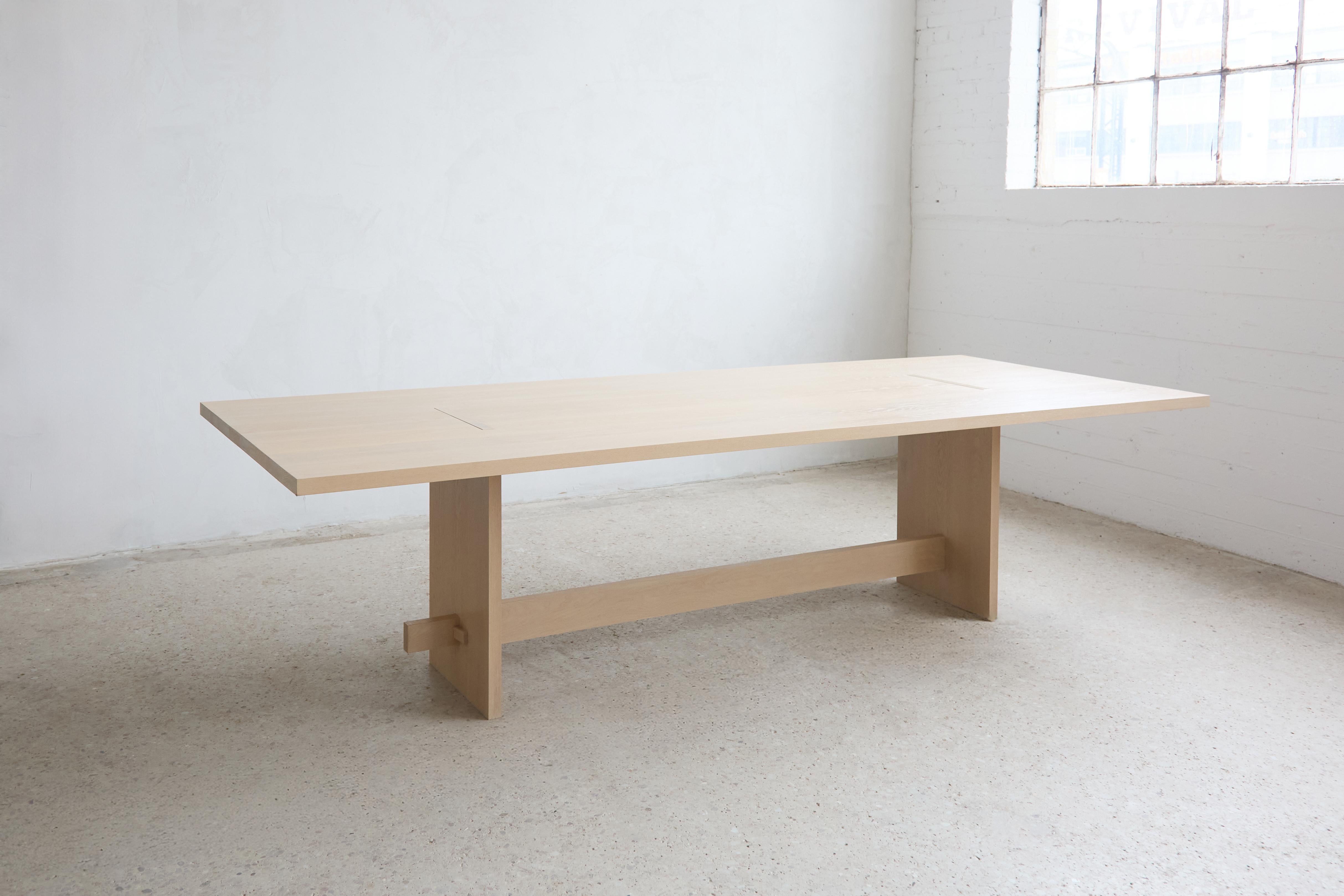 Our Himes Table explores the principals of tension and compression. Each of the six parts that make up this piece fit into one and other and are held together using these forces of strength and stability. This table features a through tenon