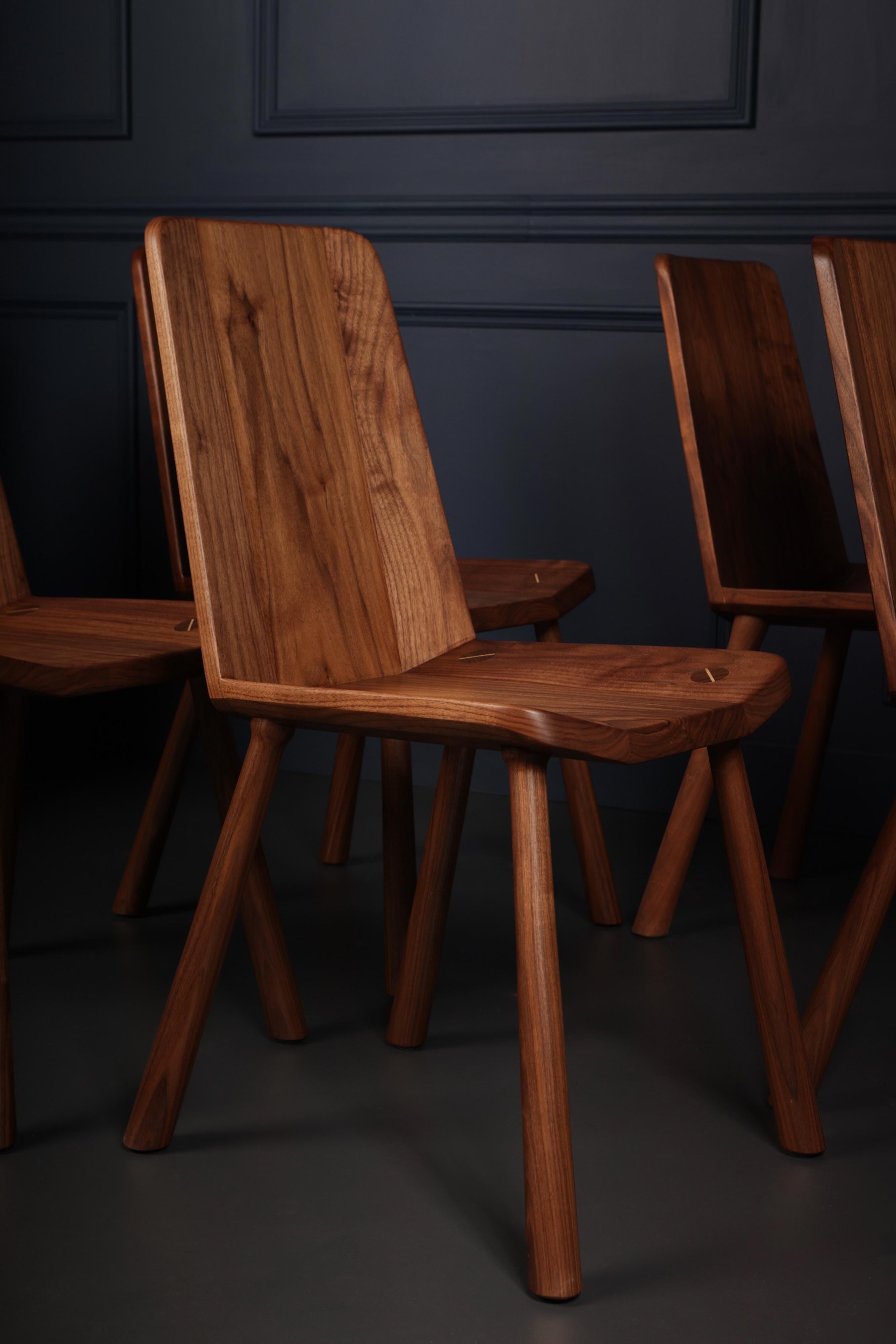 Der FIJN-Stuhl ist ein zeitgenössischer Stuhl aus facettiertem Walnussholz, das mit Bedacht in eine ergonomische Schale geformt wurde. Die Tischlerarbeiten sind sichtbar und robust, ein solides und doch verspieltes Design, das Generationen