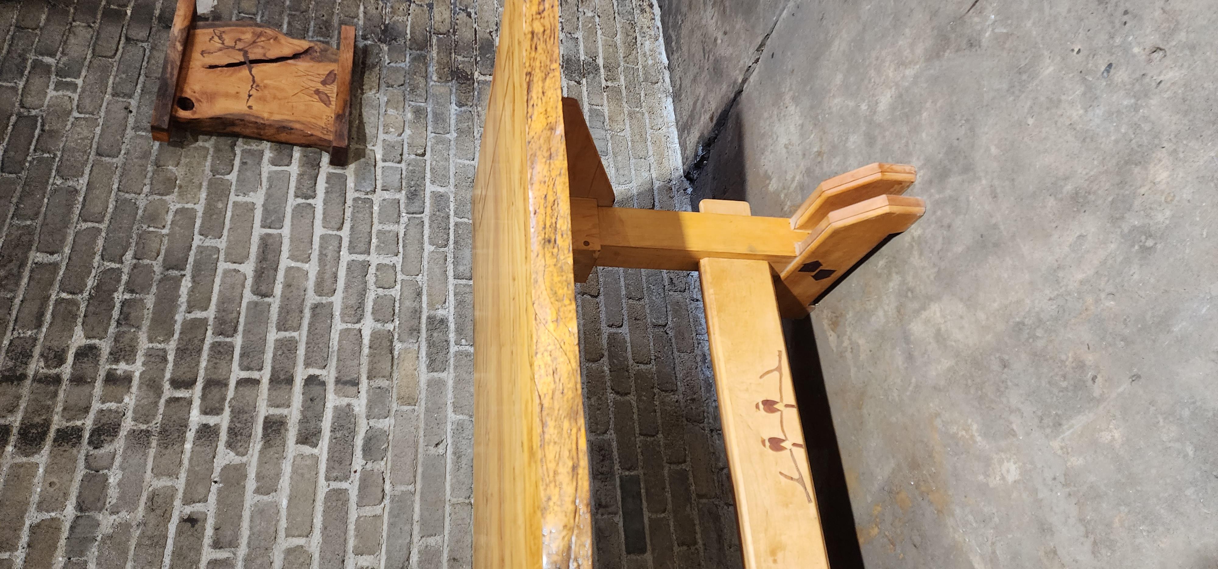 A substantial custom dining table crafted from richly figured spalted maple by craftsman PJ Spring. The top is made from a single wide slab with organic live-edge contours and dramatic natural patterning. Its surface features refined geometric