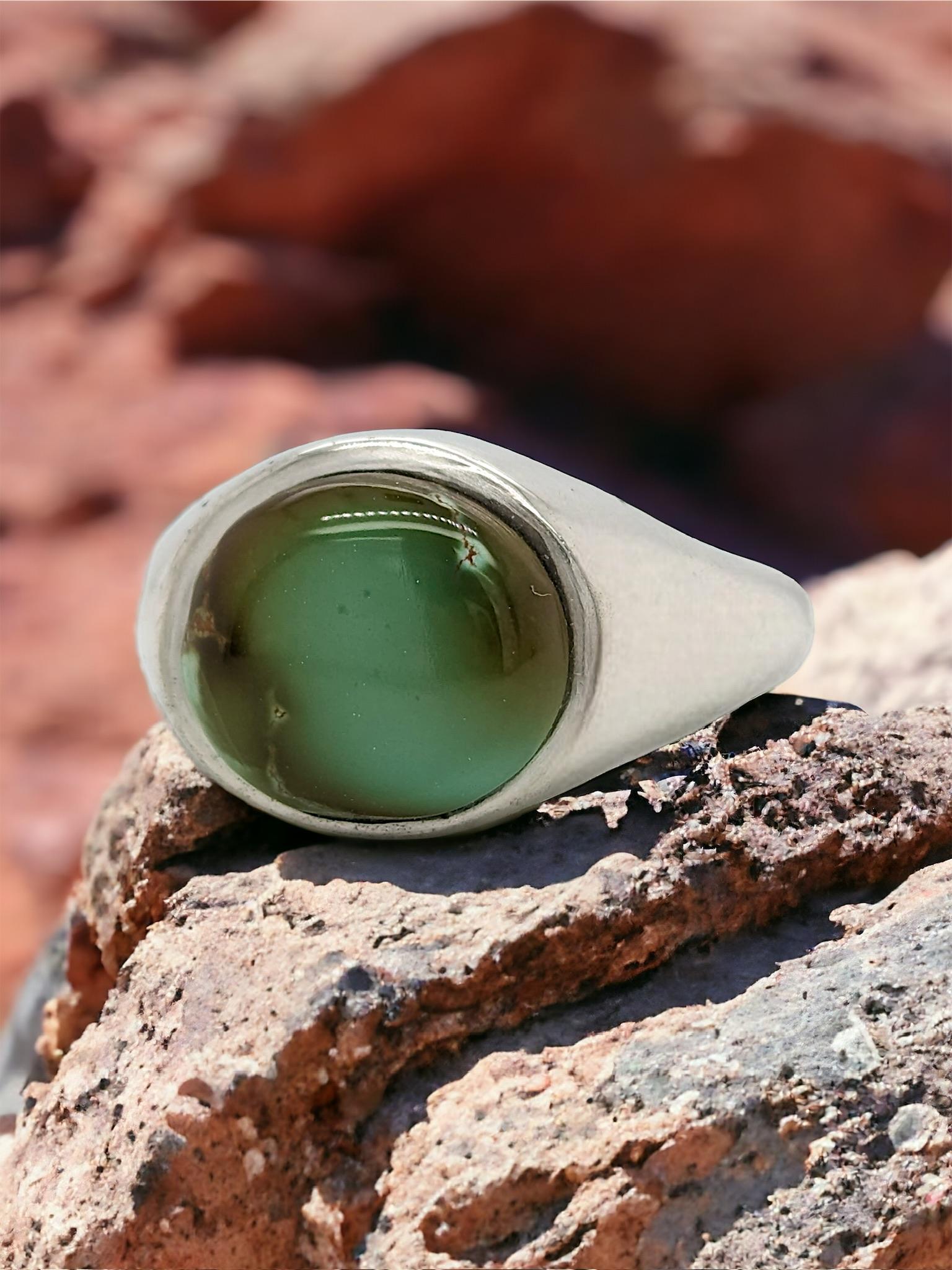 Embrace the captivating beauty of nature with this stunning Sterling Silver Oval Turquoise Ring. This timeless piece features a genuine green turquoise gemstone, boasting a captivating color that adds a touch of elegance and sophistication to any