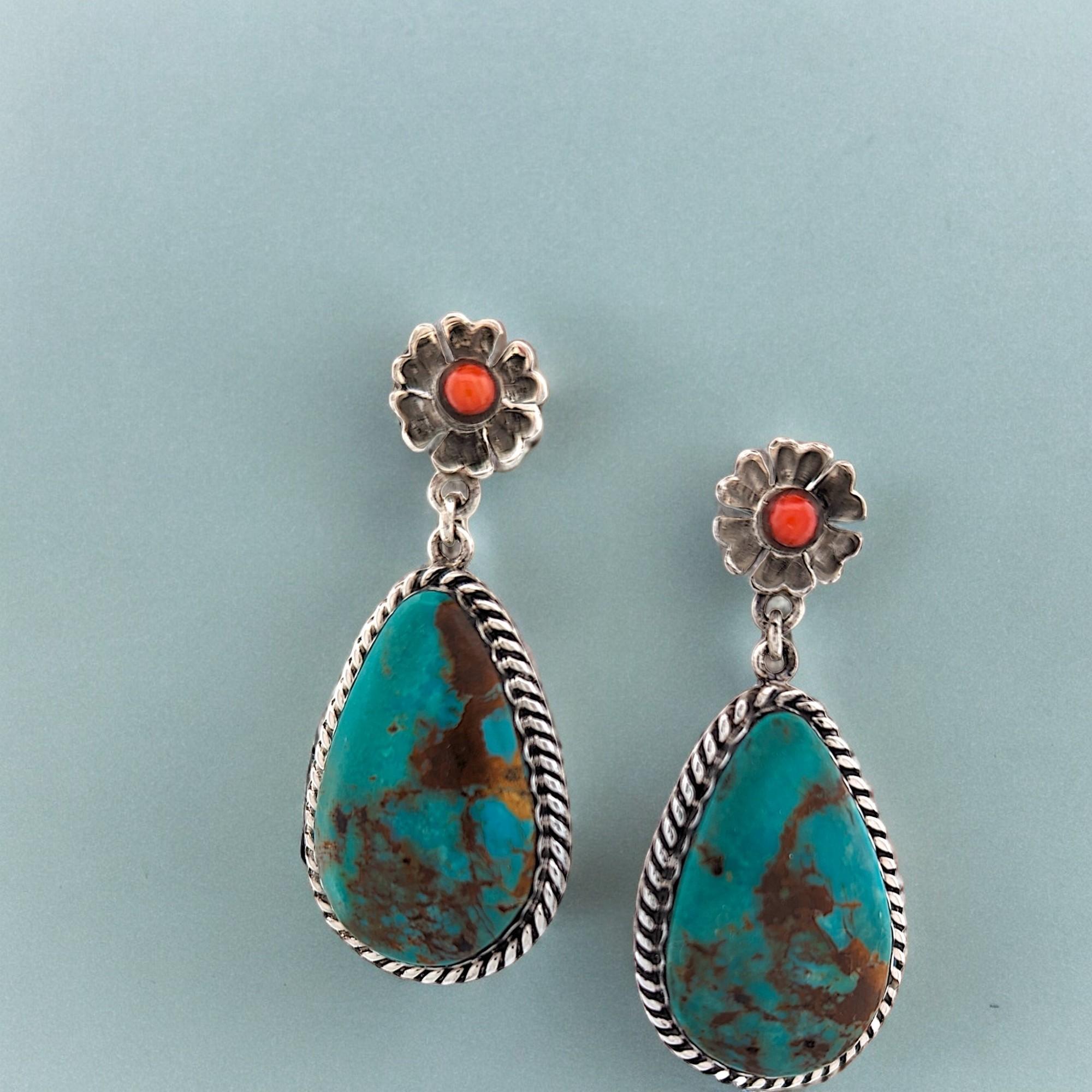Elevate your style with these exquisite, handcrafted earrings featuring authentic Kingman Turquoise and vibrant coral accents. Sterling silver settings showcase the natural beauty of these precious materials. As a unique, handmade piece, these