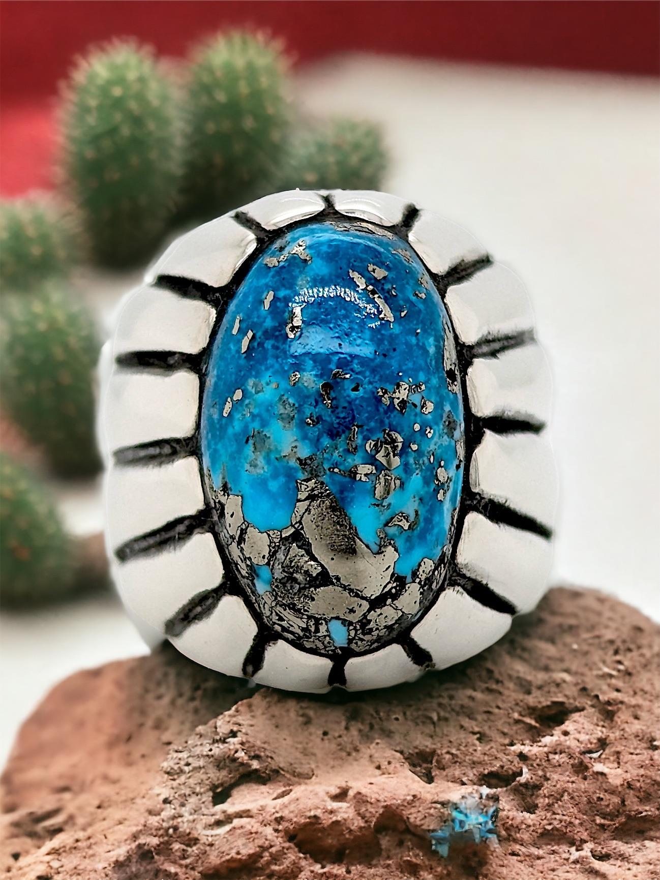Embrace the beauty of the Southwest with this captivating Handcrafted Sterling Silver.This unique piece features a genuine Kingman turquoise gemstone, known for its mesmerizing blue hues and intricate matrix patterns.

Handcrafted Artistry: This