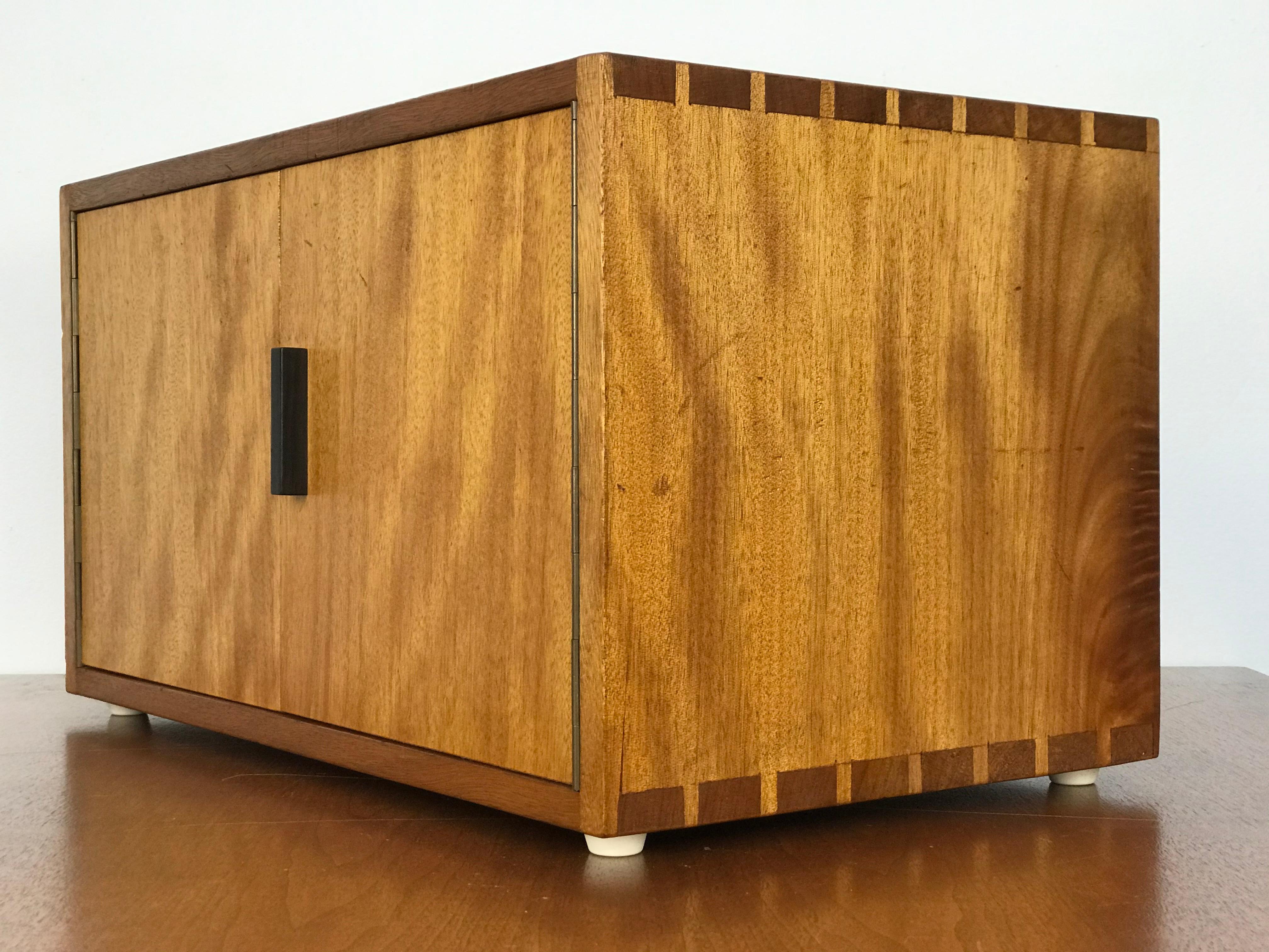 Unusual handcrafted tabletop box featuring dovetail joinery, a rosewood pull and a shelf, with circular cut-outs in the back. Unmarked/maker unknown. On four white rubber feet that keeps it in place. The box is in original condition with minor