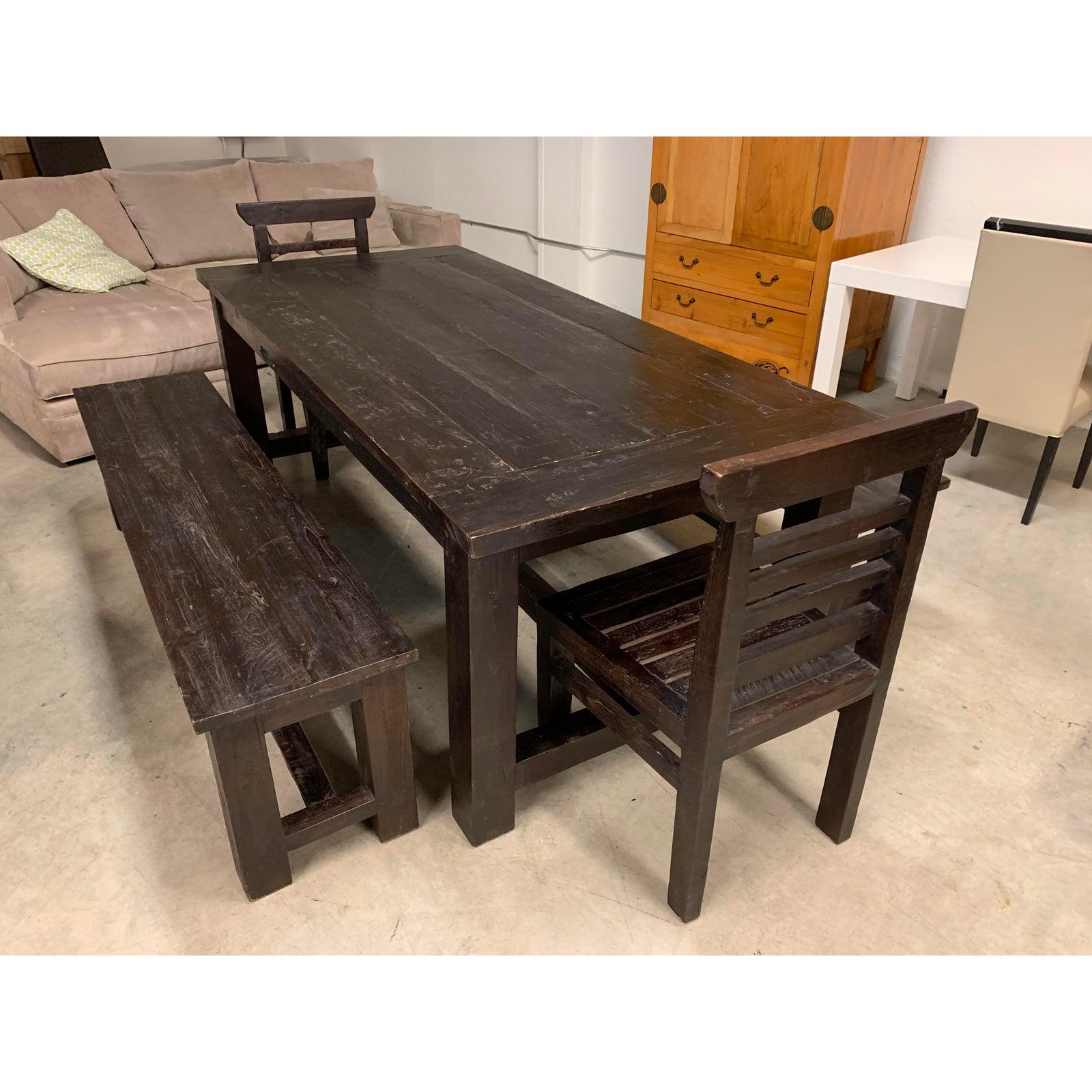 Custom crafted table set. Consist of a table, two benches and two chairs. Handcrafted from solid teak woods from a teak plantation in Jepara, central java. Stained in a dark finish. Natural distressed.

Dimensions of entire set L 121 inches x W 70