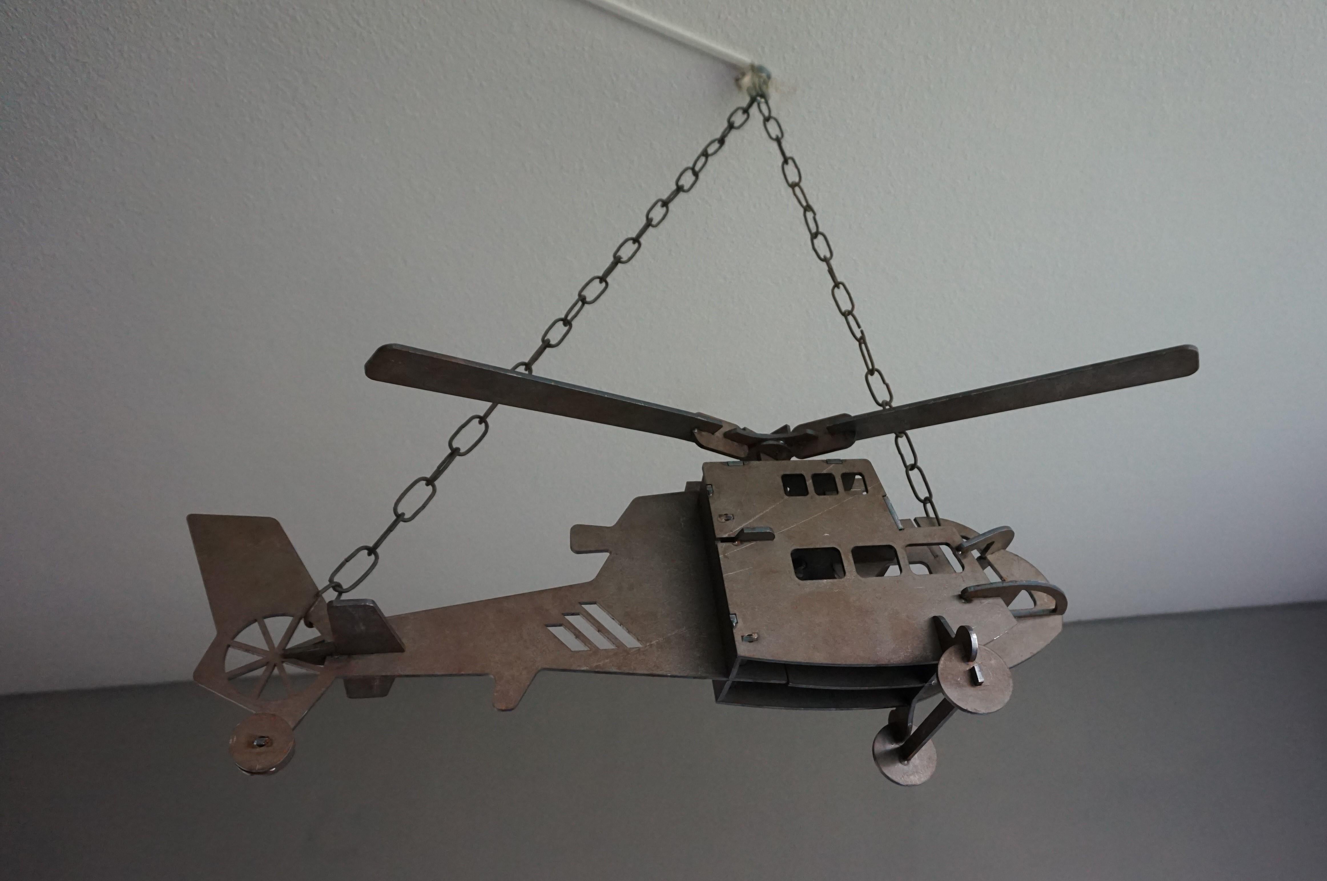 Ultimate man cave decoration that could also be turned into a light fixture.

This perfect size and all-handcrafted model helicopter was made on one of Holland's airbases. It is a one-of-a-kind that was made somewhere in the second half of the 20th