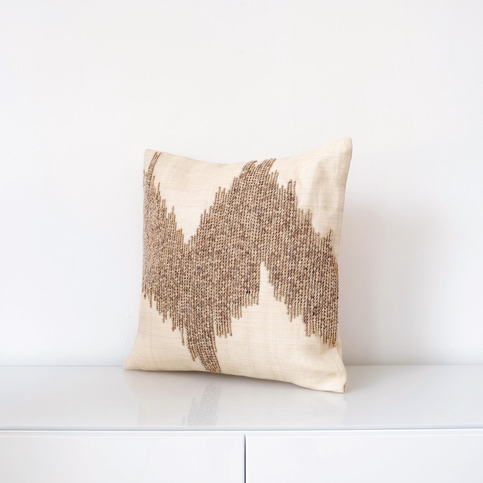 Handcrafted cushion cover made with naturally dyed and delicately woven T’nalak cloth from Abaca fibres and fastened with coconut shell buttons
Colour: light sand and oatmeal

Measures: 45 x 45 cm
17.7? x 17.7?
Recommended cushion filler: 56 x