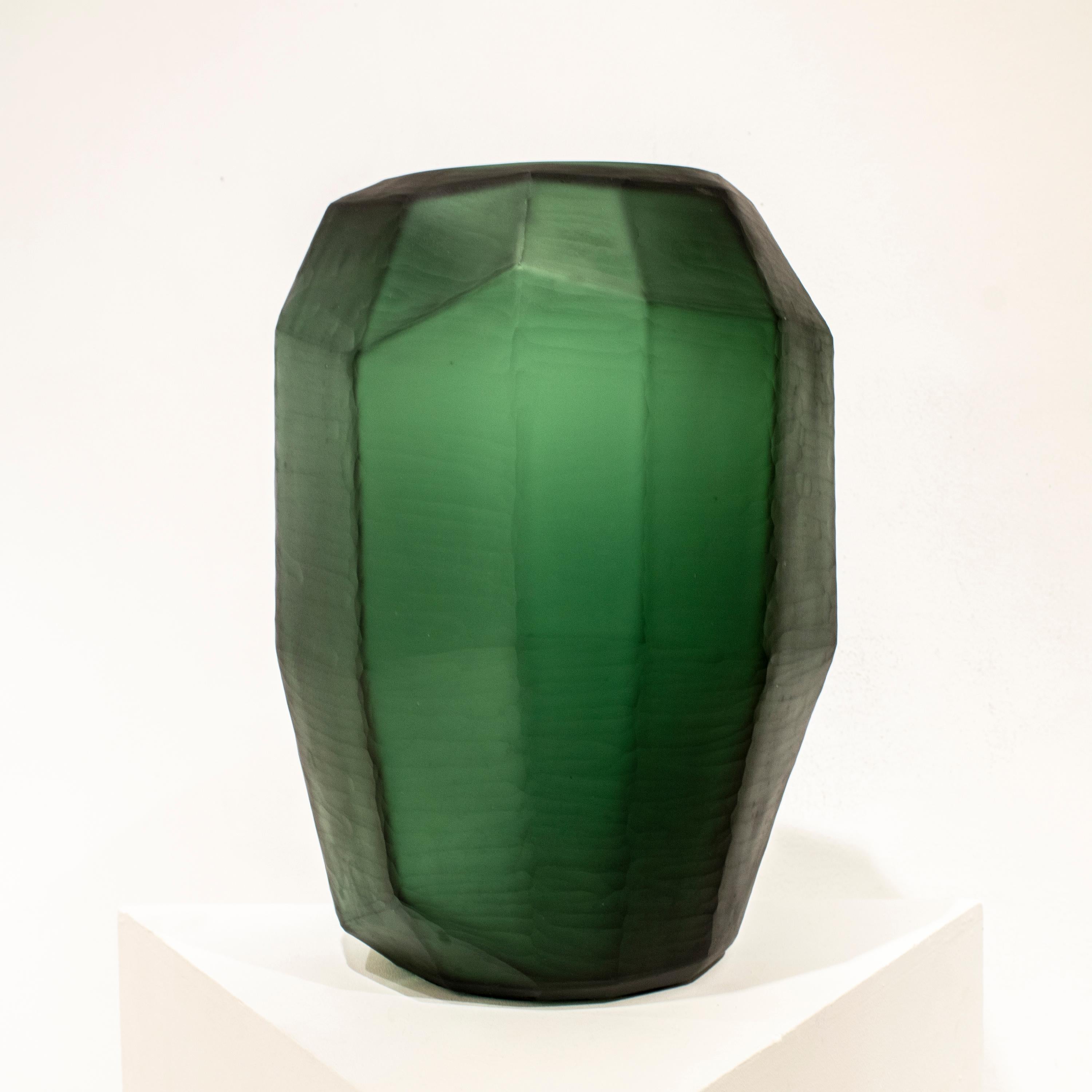 Italian green translucid glass vase, with faceted polygonal shape and a matted finish. 