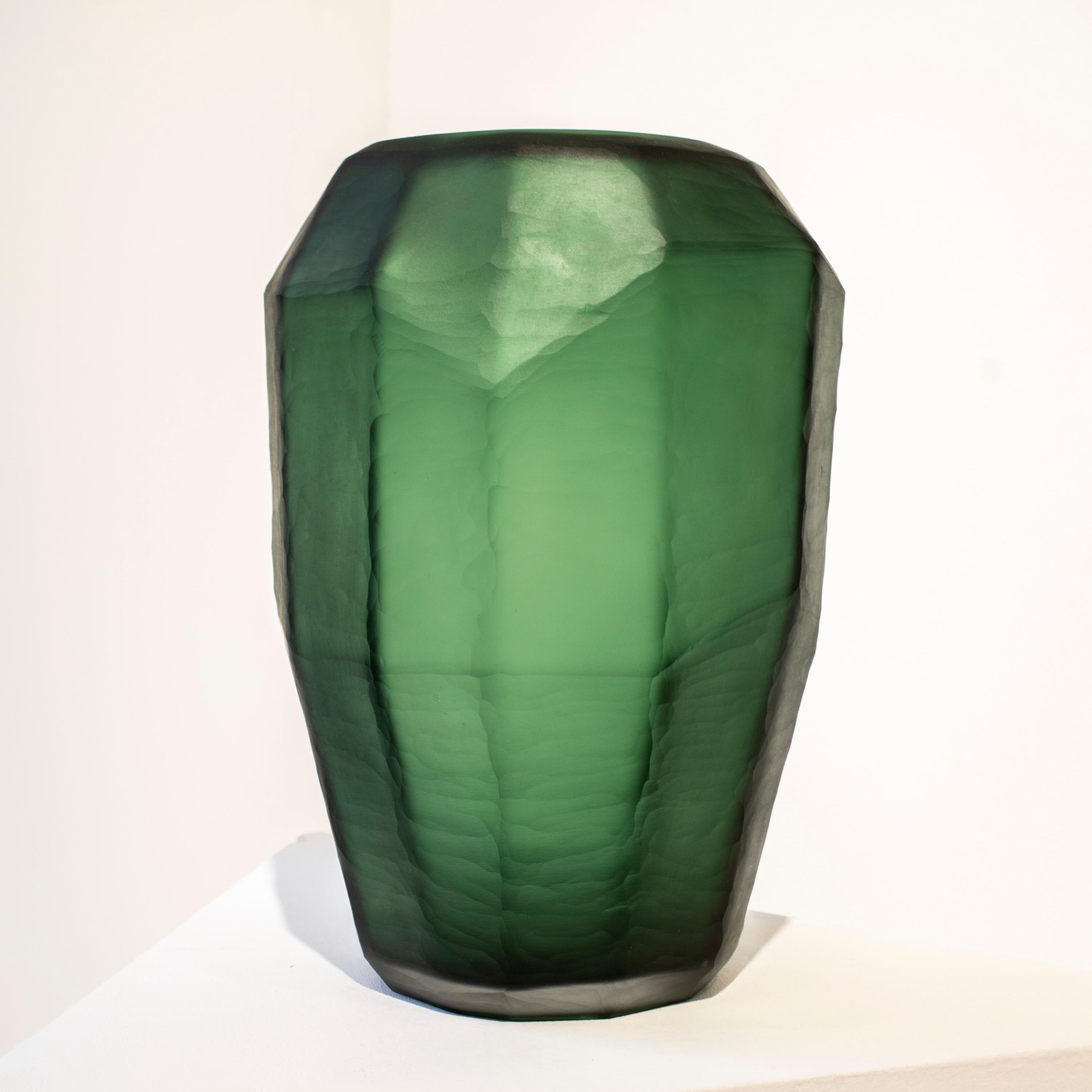 Italian green translucid glass vase, with faceted polygonal shape and a matted finish. 