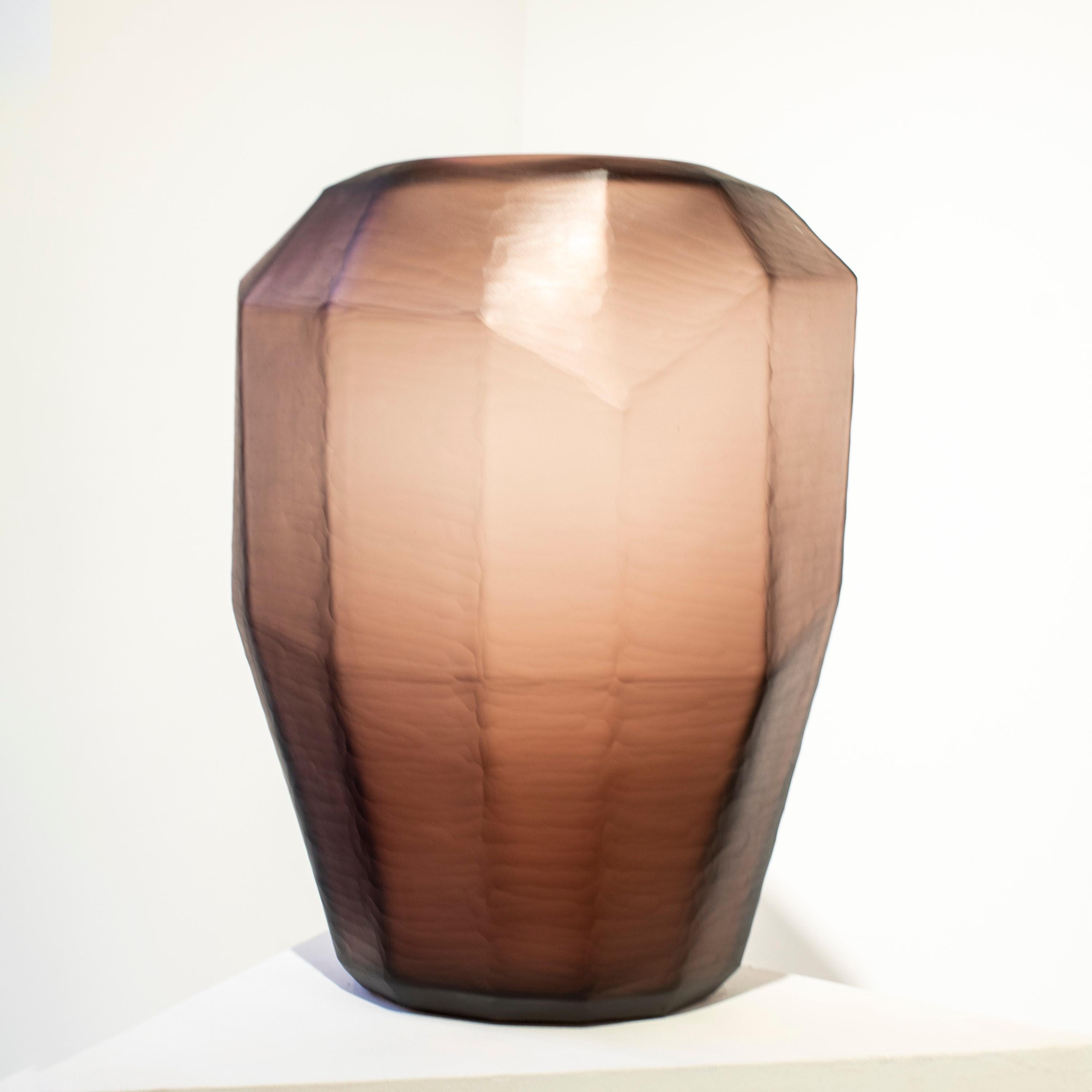 Italian magenta translucid glass vase, with faceted polygonal shape and a matted finish. 