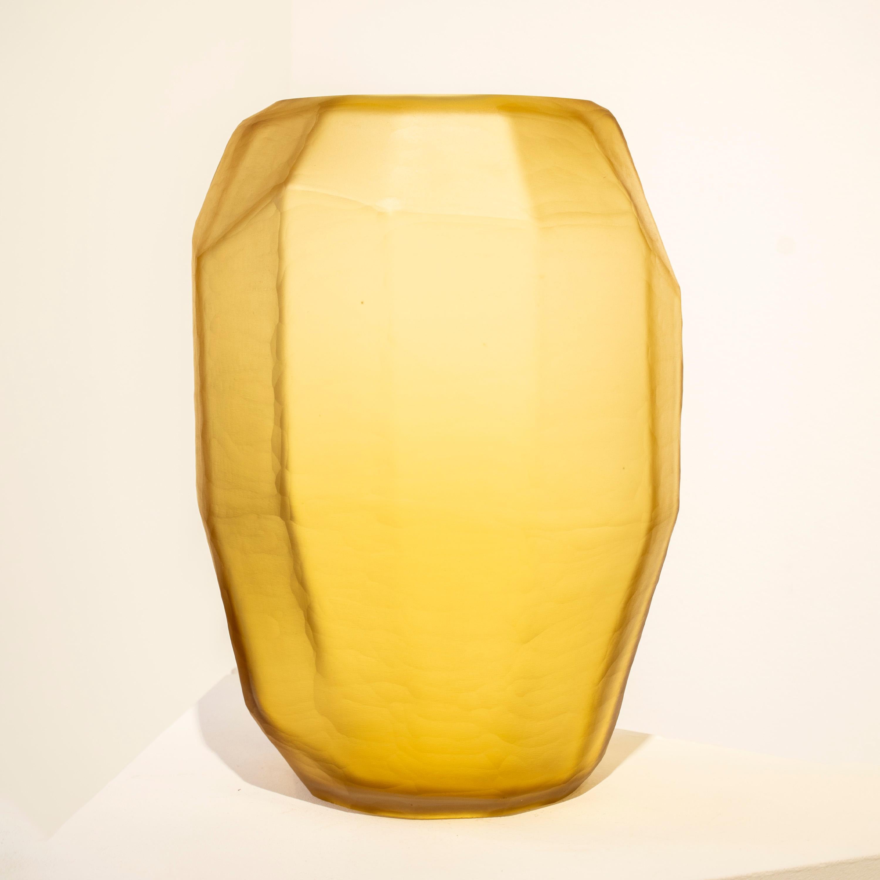 Italian yellow translucid glass vase, with faceted polygonal shape and a matted finish. 