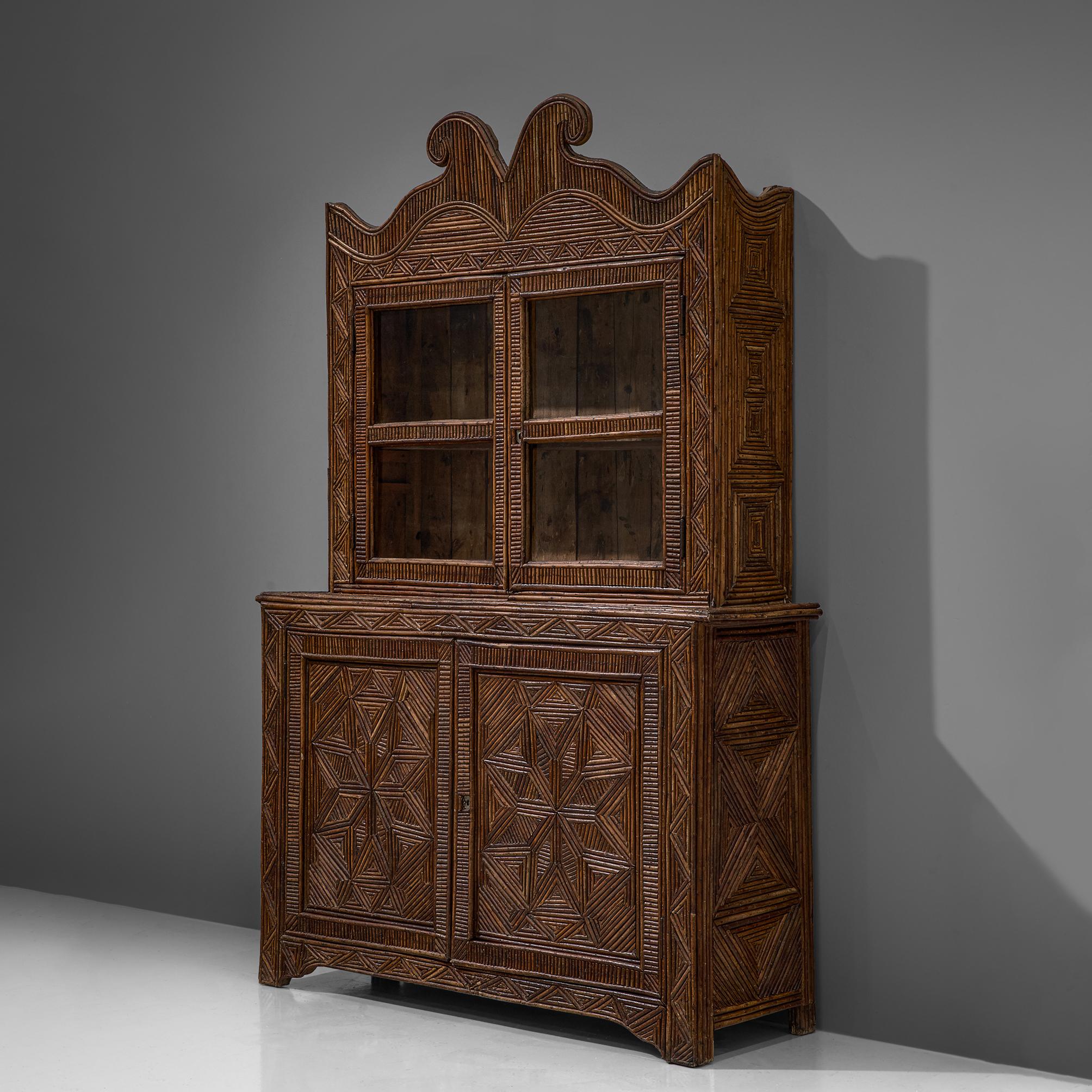 Cabinet, birch twig wood, glass, Europe, 1940s

Unique highboard with mosaic of wooden twigs. The surface of the base cabinet with two doors and also the top display cabinet is fully covered with wooden slats in different lengths, creating a