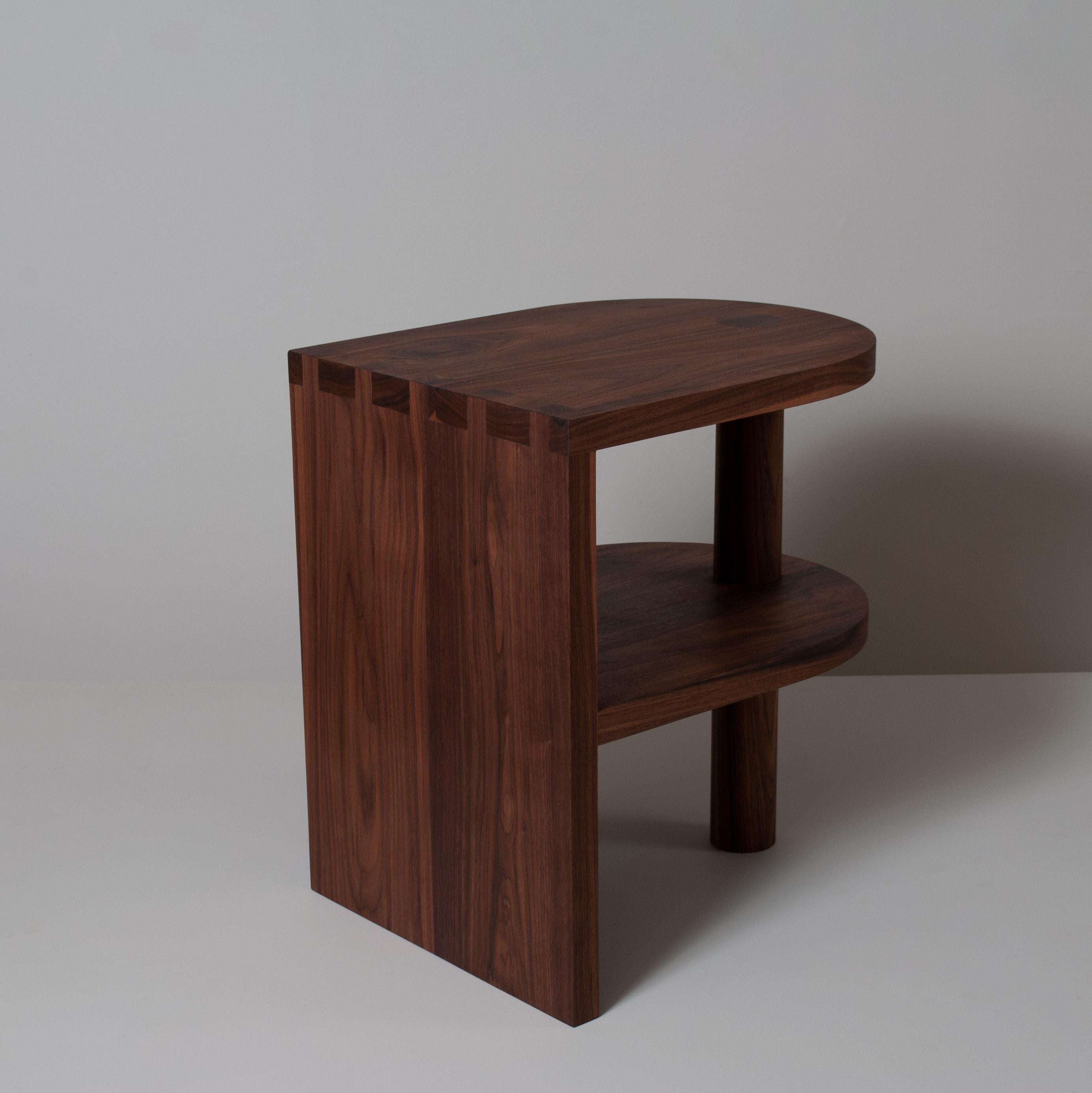 Handcrafted architectural American black walnut nightstand. Designed at Sum furniture and handcrafted using traditional furniture making techniques with the finest American Black Walnut. Hand-cut oversized dovetail jointing detail with a thick