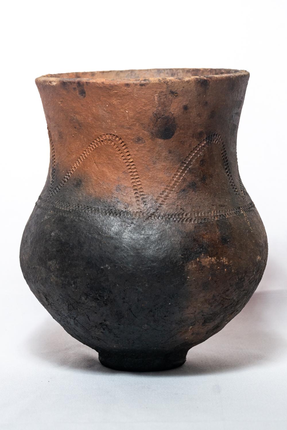 Elevate your interior with the sophisticated charm of our Handcrafted wood ash-fired clay Vase, made from the finest local clay. This exquisite piece undergoes an intricate wood-ash firing process, which involves applying layers of ash to the clay