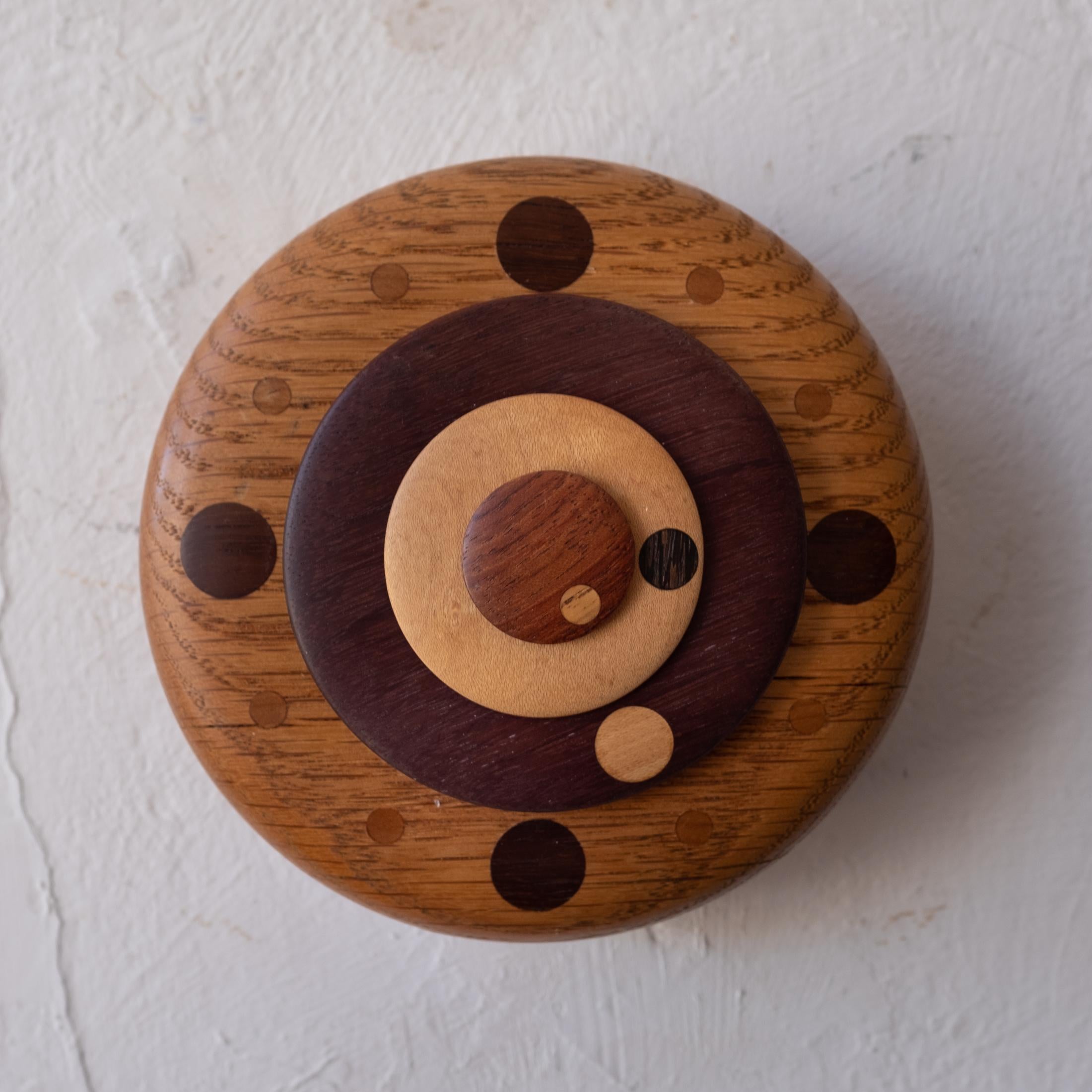Amazing artist made wood clock. Has hour, minutes and seconds. Incredible craftsmanship with mixed woods. Signed on the back. New movement that keeps perfect time.