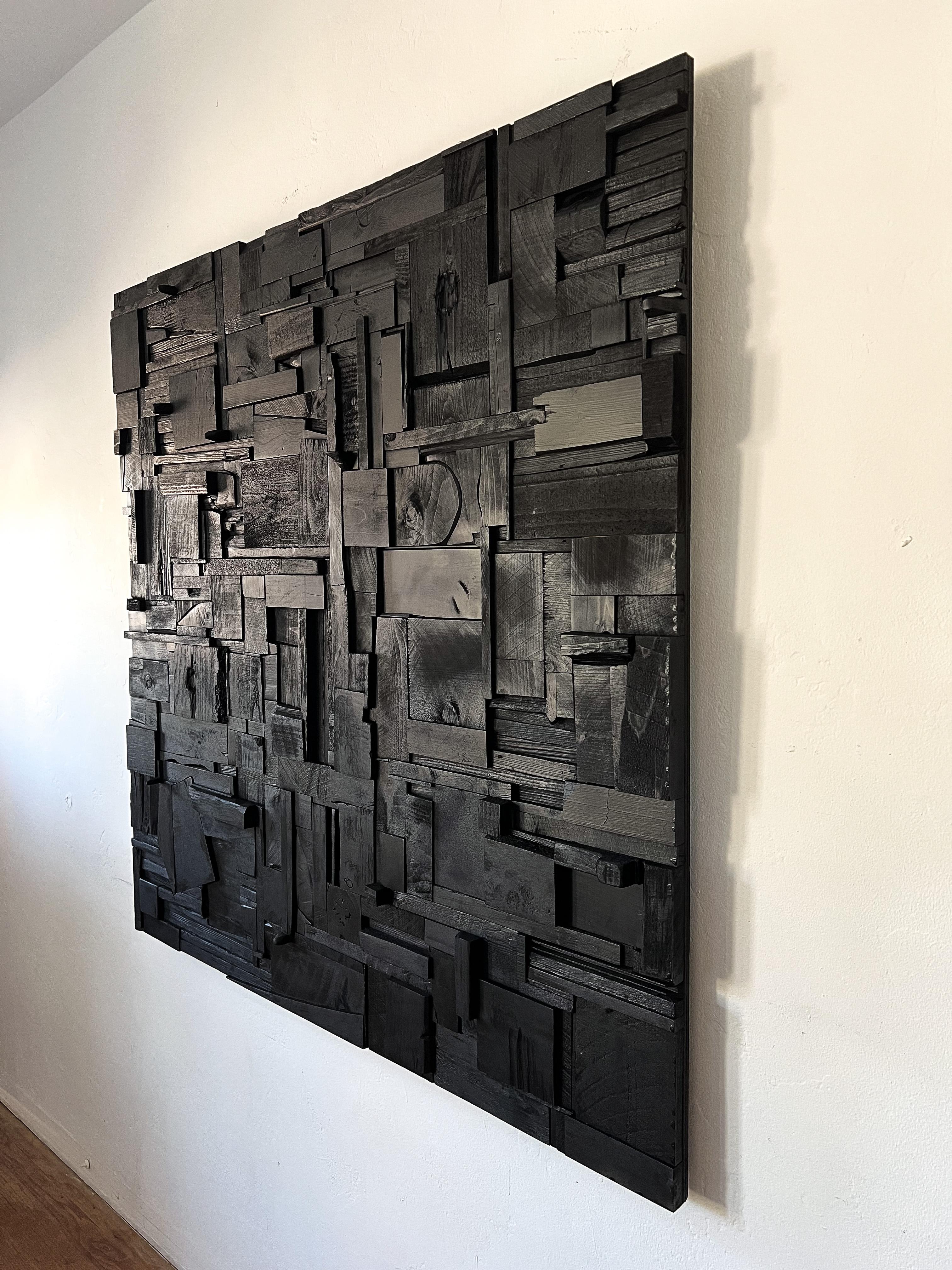This striking wooden wall sculpture is a one-of-a-kind statement piece that embodies the bold aesthetics of brutalist design. 

Meticulously constructed from reclaimed wood, the composition features an intricate arrangement of geometric forms,