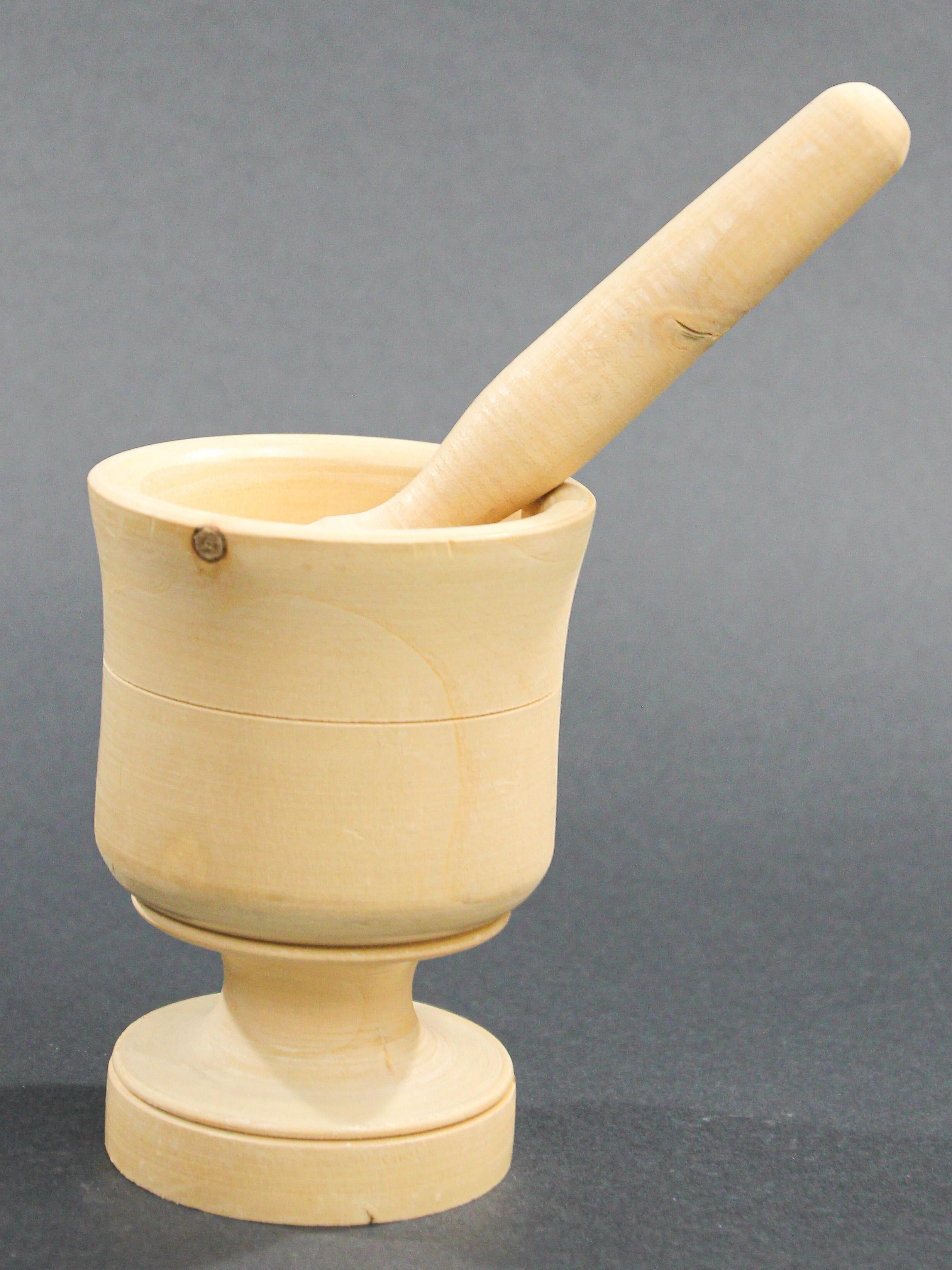 Wooden footed mortar and pestle hand turned and carved from one piece of dense fruitwood. 
Handcrafted by artisan in Italy, hand turned wood Mortar and Pestle.
Display it on your kitchen island or in a bookcase and just gaze upon its beauty 
This
