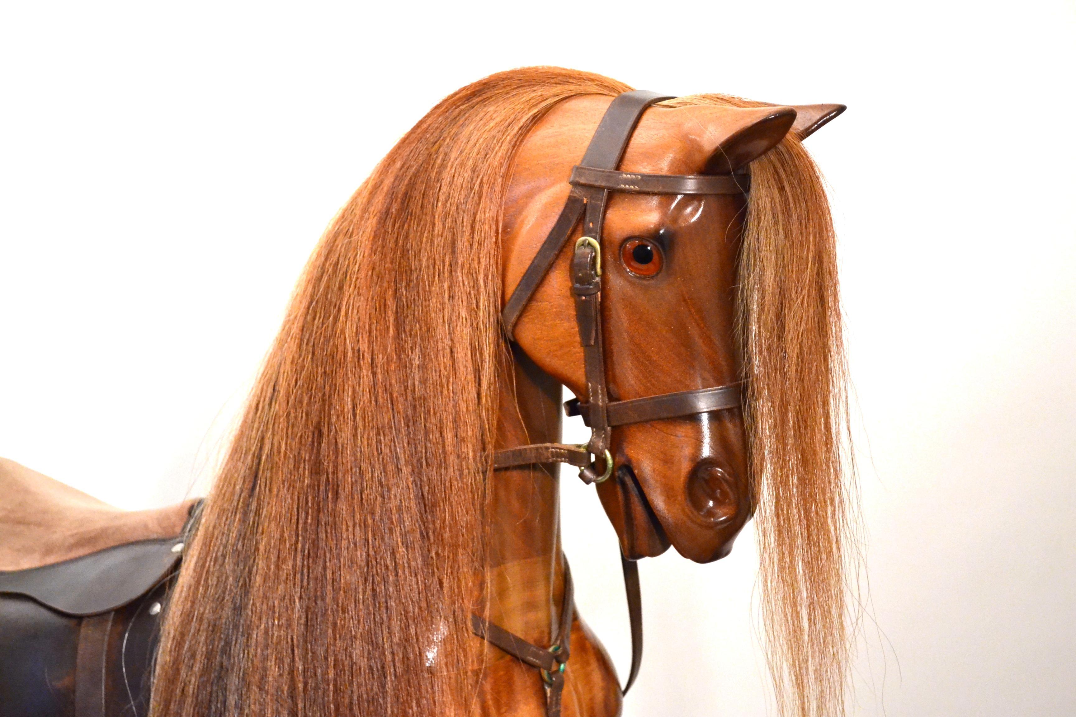 Handcrafted wooden rocking horse by Geoff Martin

A fine handcrafted chestnut rocking horse by Geoff Martin of Horsecraft. With arched neck and pricked ears glass eyes and real horse hair mane and tail. Hand stitched leather bridle and martingale