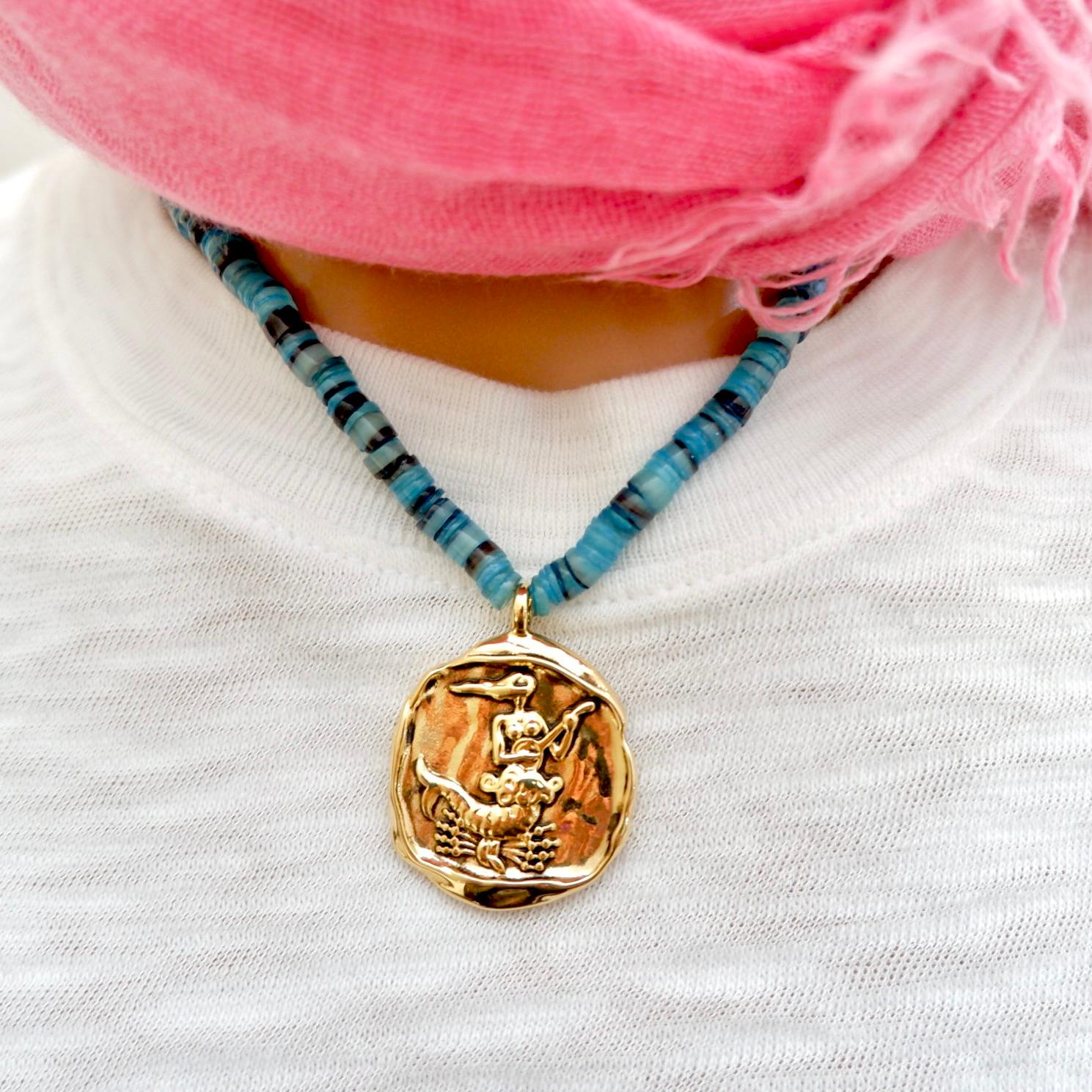Handcrafted Necklace in collaboration with Adriana Bittencourt, hammered brass zodiac astrology pendants, hand strung Brazilian puka shells in the most beautiful colors, necklace measuring 18” in length. We are obsessed with this colorful unique