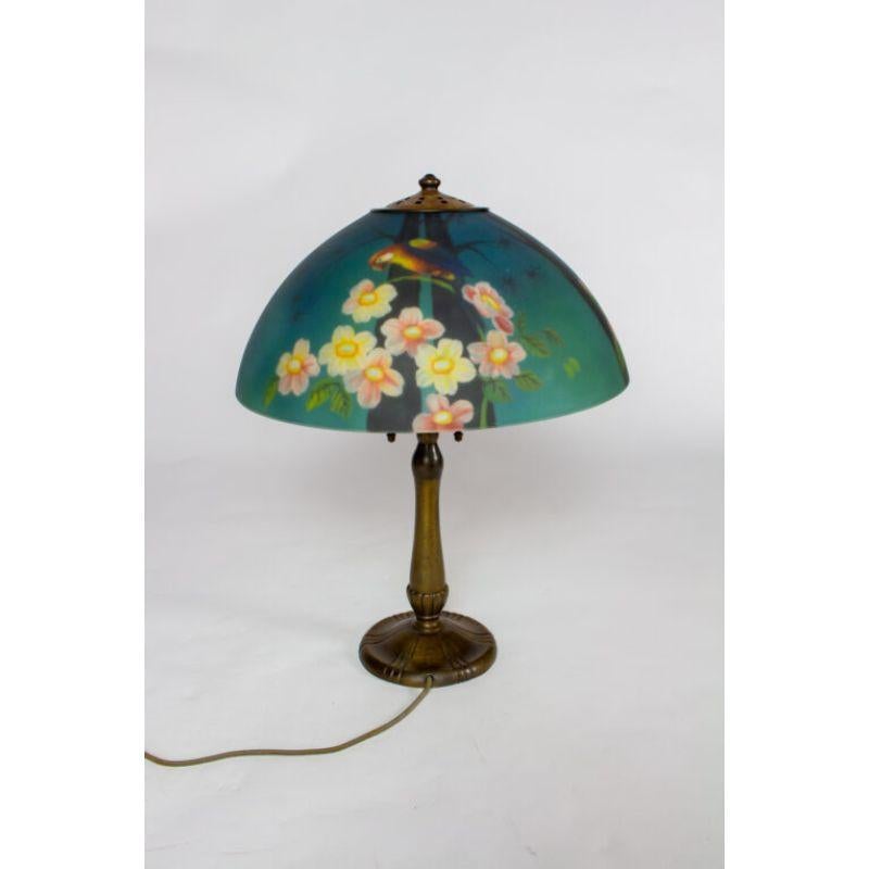 Handel base cleaned and wax polished original finish, with replacement reverse painted glass shade. Shade has an image of a parrot and flowers.

Material: Glass,Metal
Style: Traditional
Place of Origin: United States
Period made: Early 20th