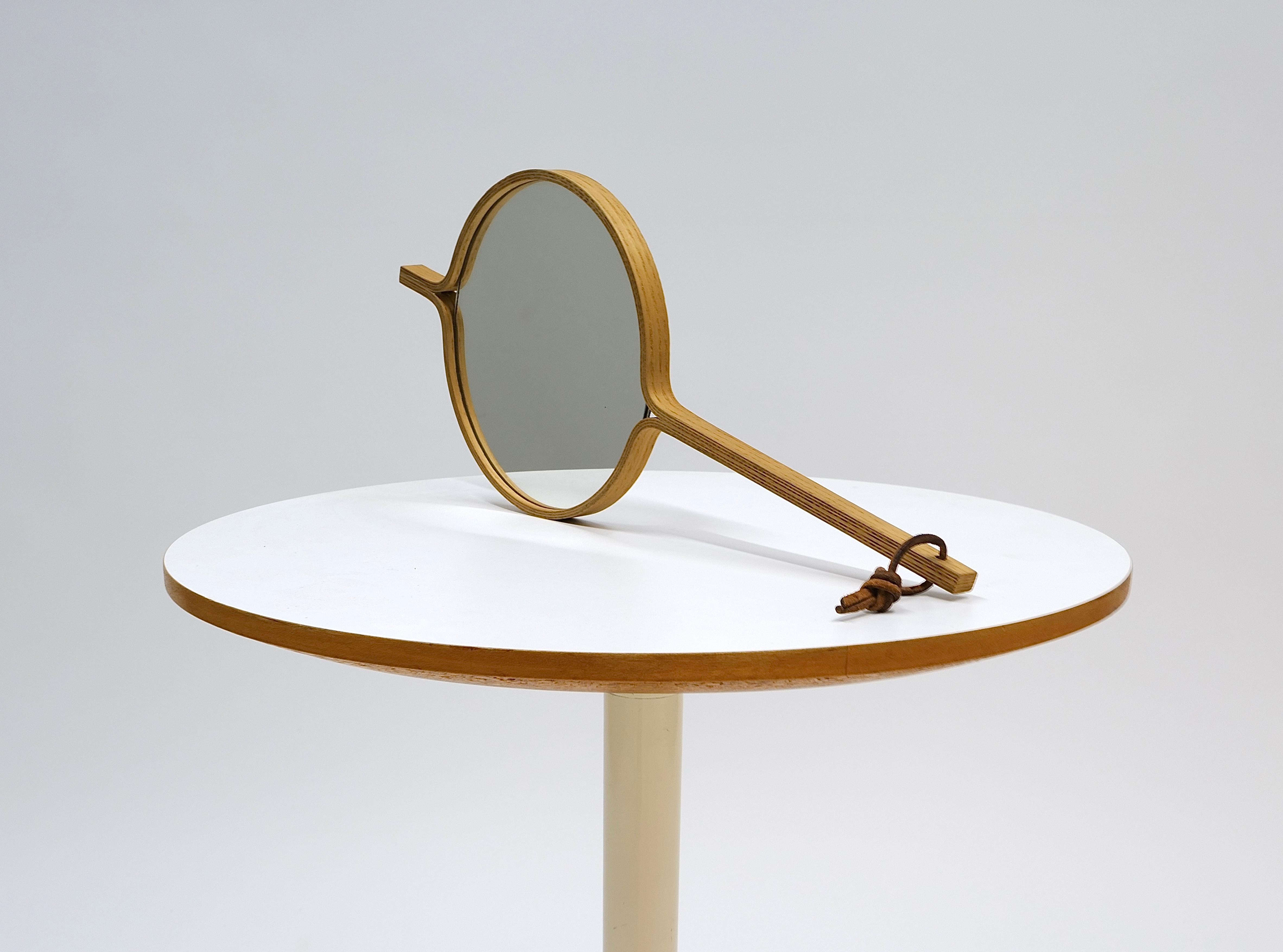 This rare handheld mirror, designed by Jørgen Gammelgaard, exemplifies the refined simplicity and expert craftsmanship of Danish mid-century design. Made from exquisite white oak, the mirror features a smooth handle that fits comfortably in the