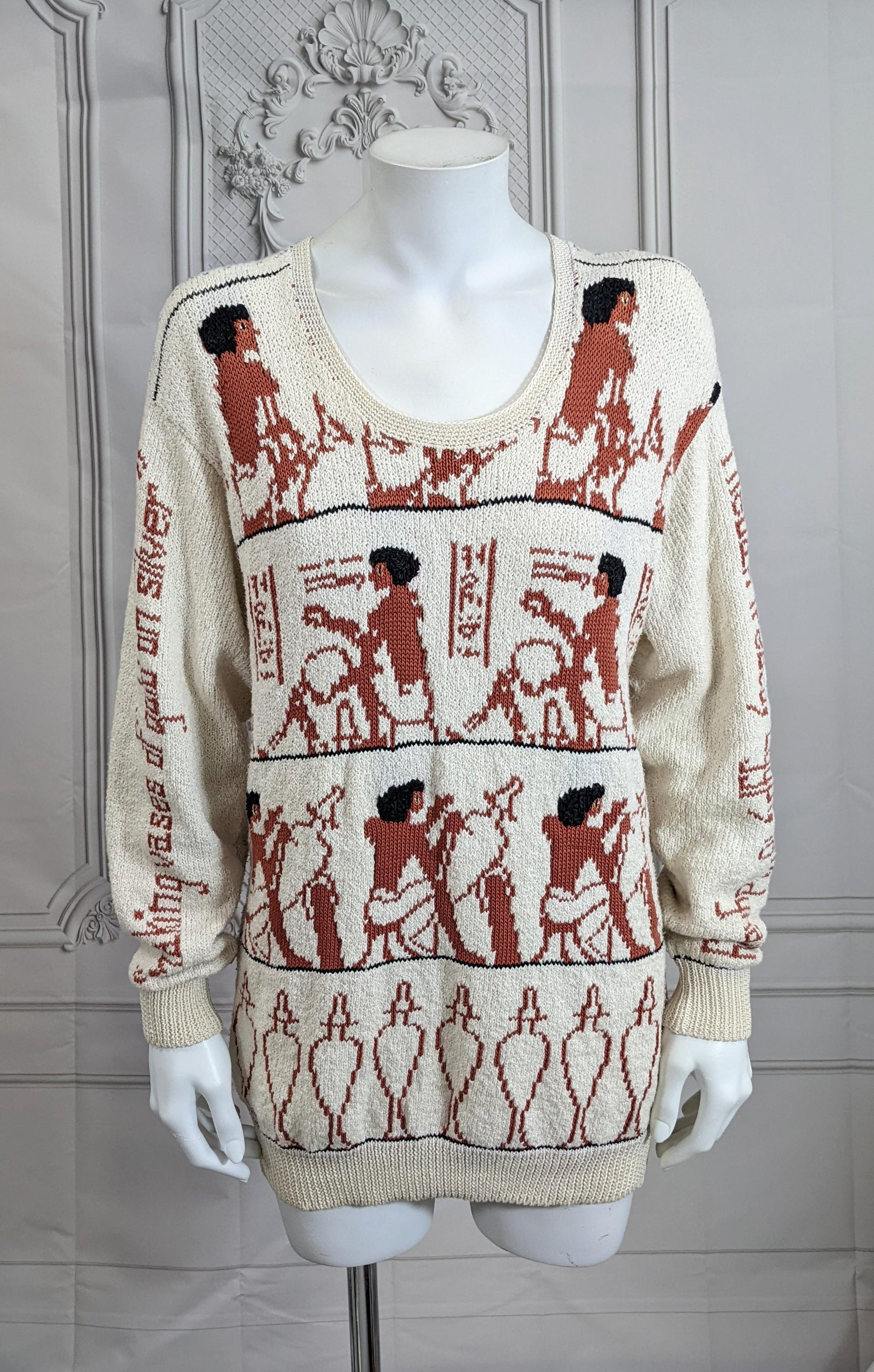 Charming and unusual Handknit Cotton Eygptian Themed Sweater by Dia North of Boston circa 1980's. Motifs include the creation of silver and gold urns and the process is described running down each sleeve.  Size S/M. Vermont 1980's. 
Bust 34