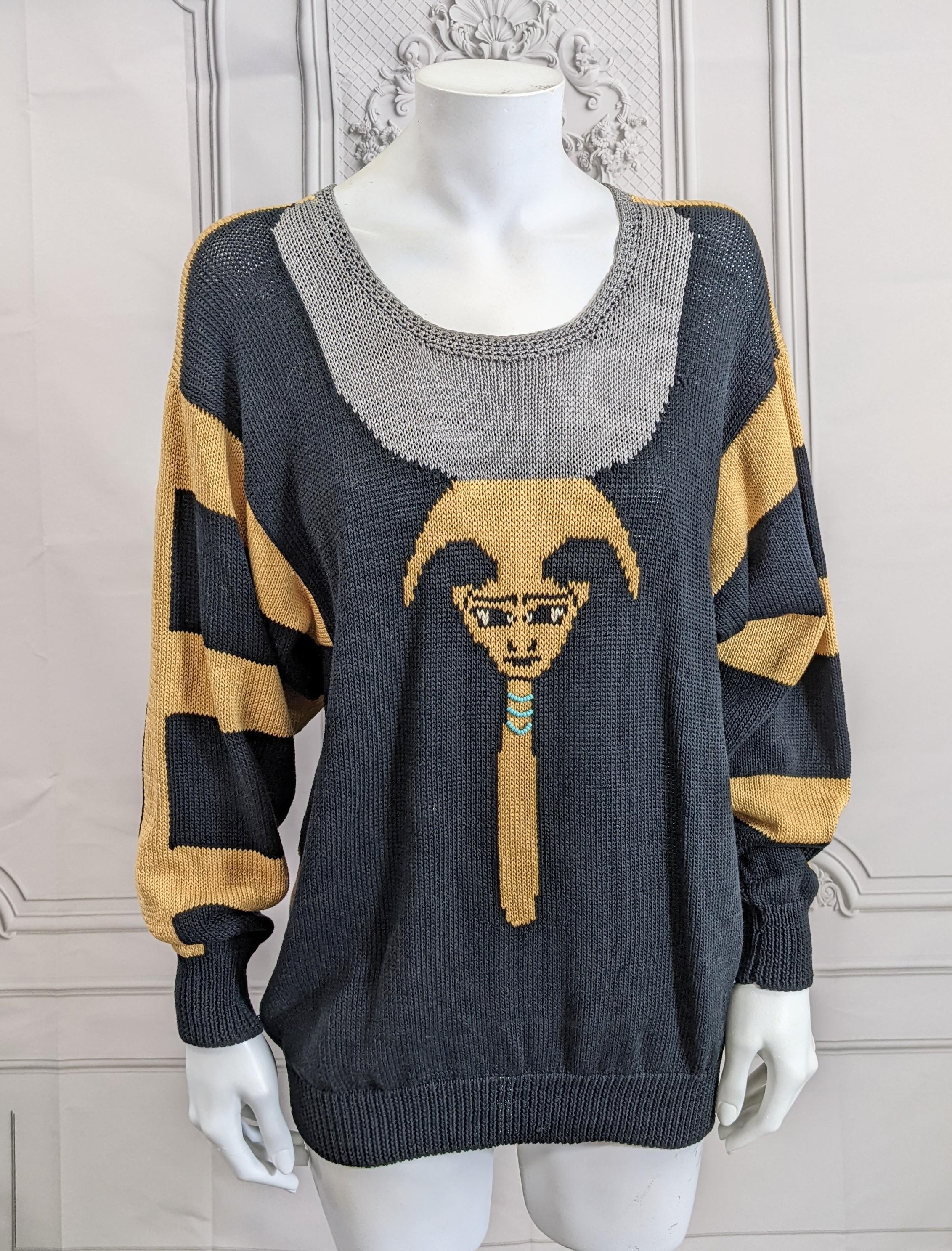 Charming and unusual Handknit Cotton Eygptian Themed Sweater by Dia North of Boston circa 1980's. Motifs knitted in black, grey and gold with central god adorned with turquoise beadwork.  Size Small-Medium. Vermont 1980's.
26