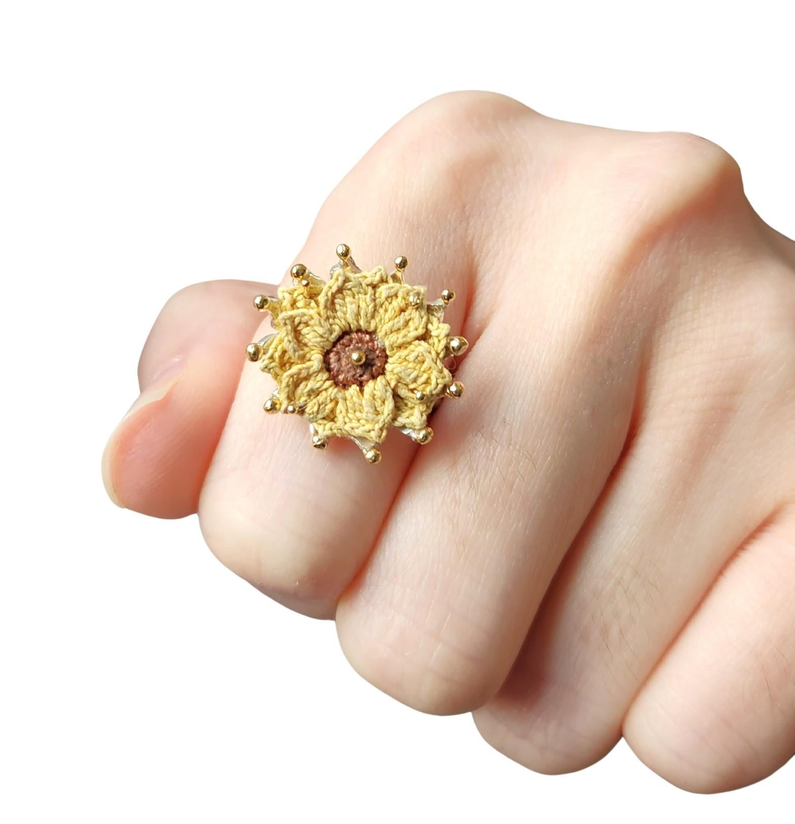 A small collection of handknit spring flowers that are a component part of a handmade ring it sits on. Each flower is a one of a kind. Gold accents are added to tips of the petals. Each knit flower and ring is custom made to fit the silhouette of
