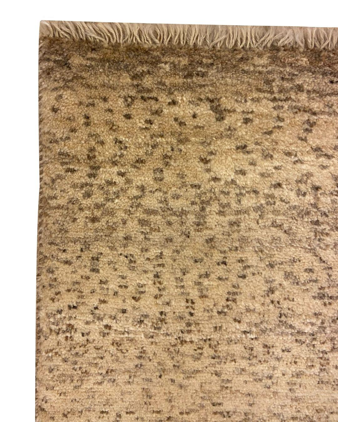 This handknotted modern organic Persian rug in neutral cream and brown, measuring 3' x 5', is a celebration of simplicity and artisanal craftsmanship. The rug’s simple yet refined textural design showcases the beauty of natural wool, handspun and