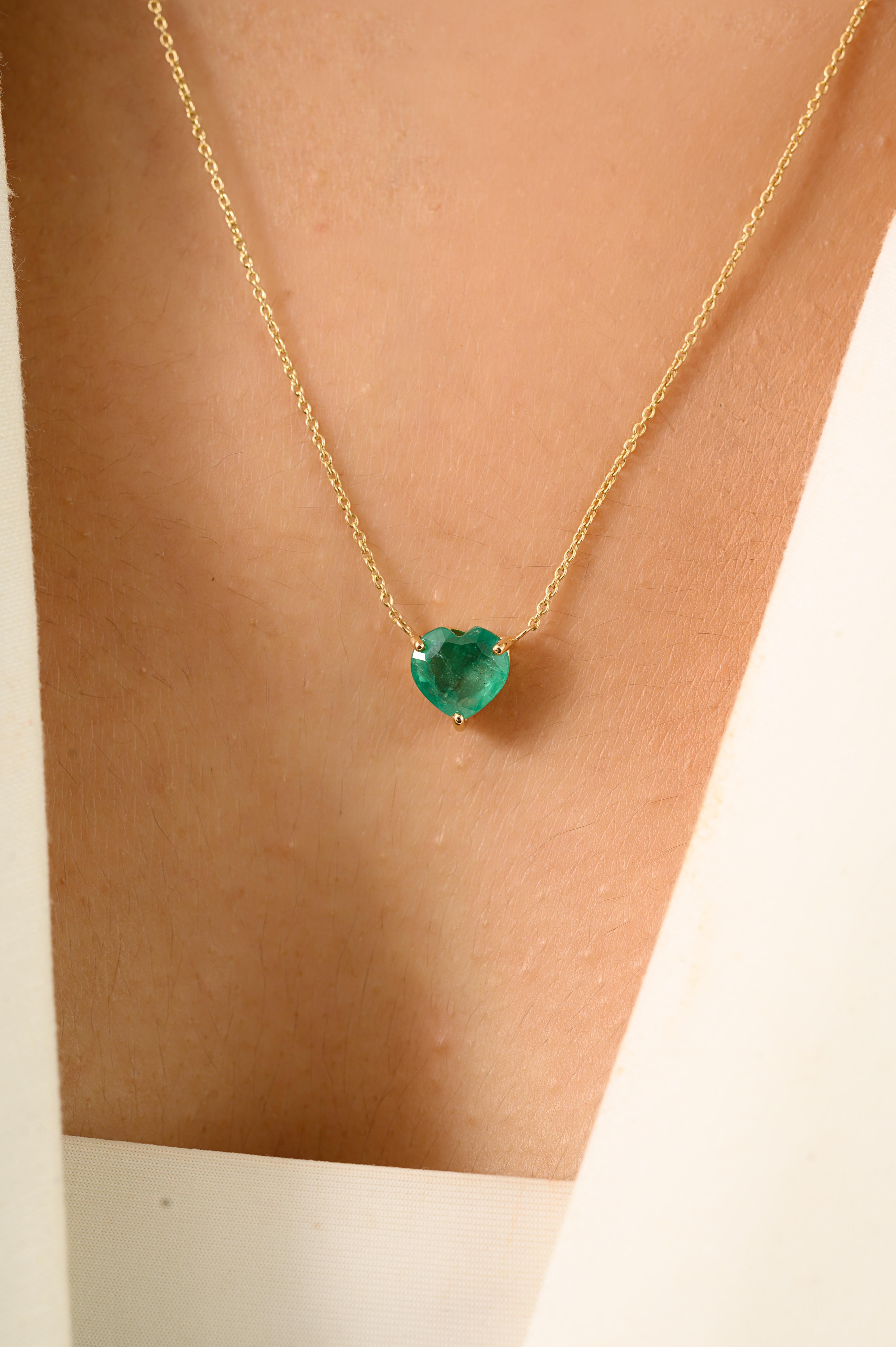 This elegant pendant necklace features a 1.25 carat heart-cut emerald, securely set in a classic prong setting that highlights its brilliance. Crafted in 14k yellow gold, the pendant is suspended from a fine gold chain, offering a total length of 18