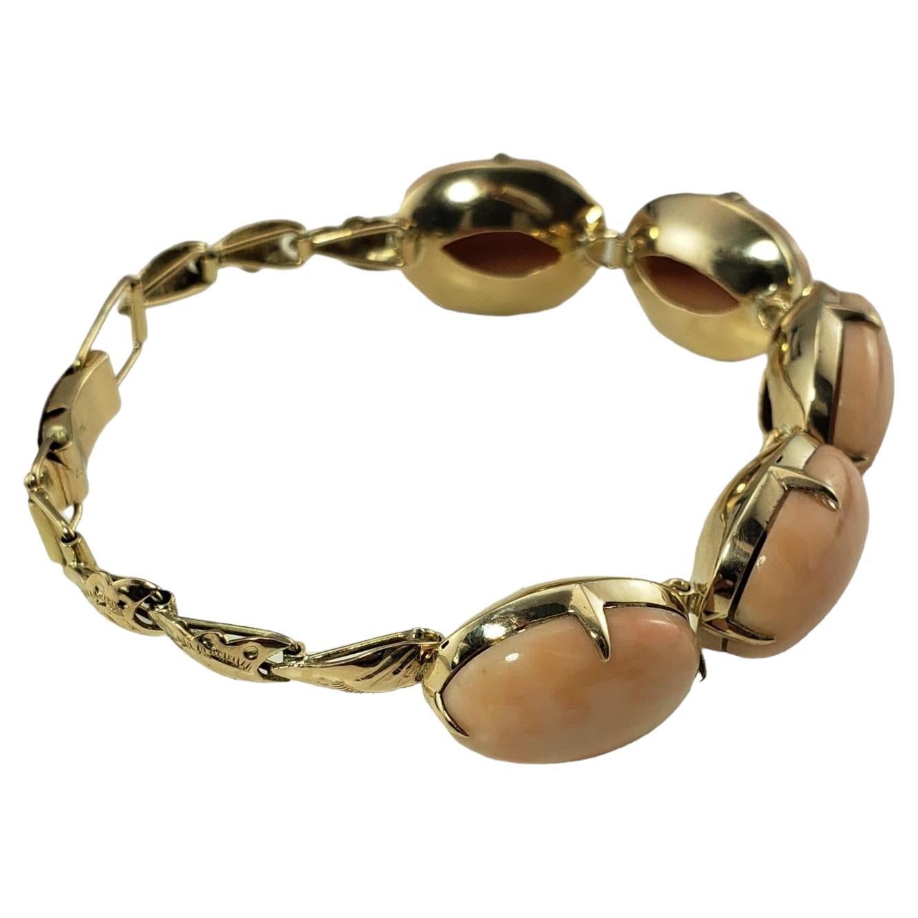 Vintage 14 Karat Yellow Gold and Coral Bracelet-

This lovely handmade bracelet features five coral stones (19 mm x 14 mm) set in classic 14K yellow gold.  

Size:  6.5 inches (adjustable)

Weight: 20.8 gr./ 13.3 dwt.

Stamped: 14K

Very good