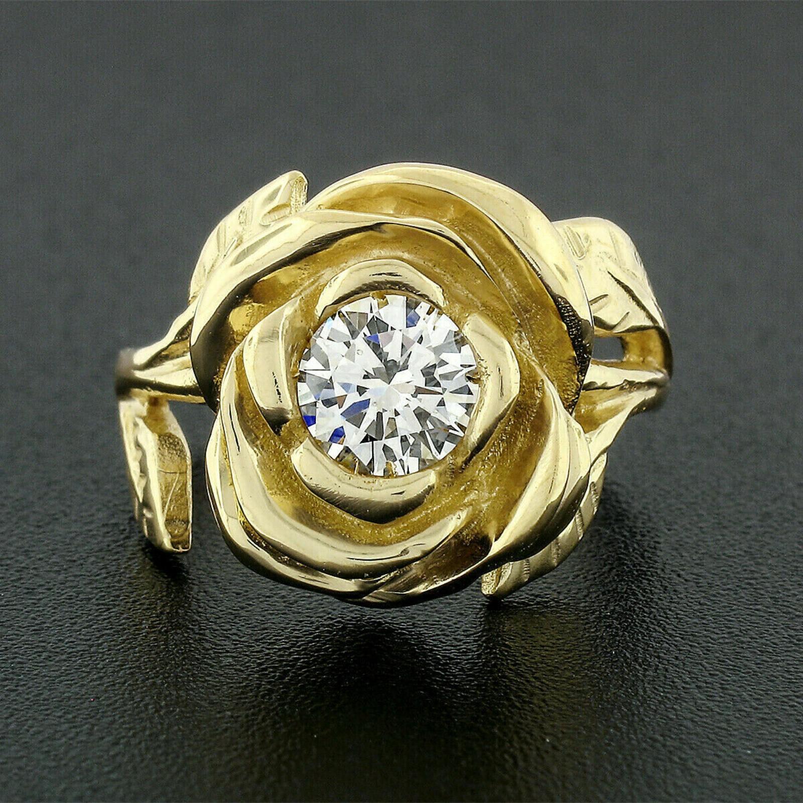 Here we have a gorgeous diamond rose flower ring hand crafted in solid 18k yellow gold. The ring features a very unique and truly heart warming rose flower design, prong set with a round brilliant cut at its center. This solitaire diamond weighs