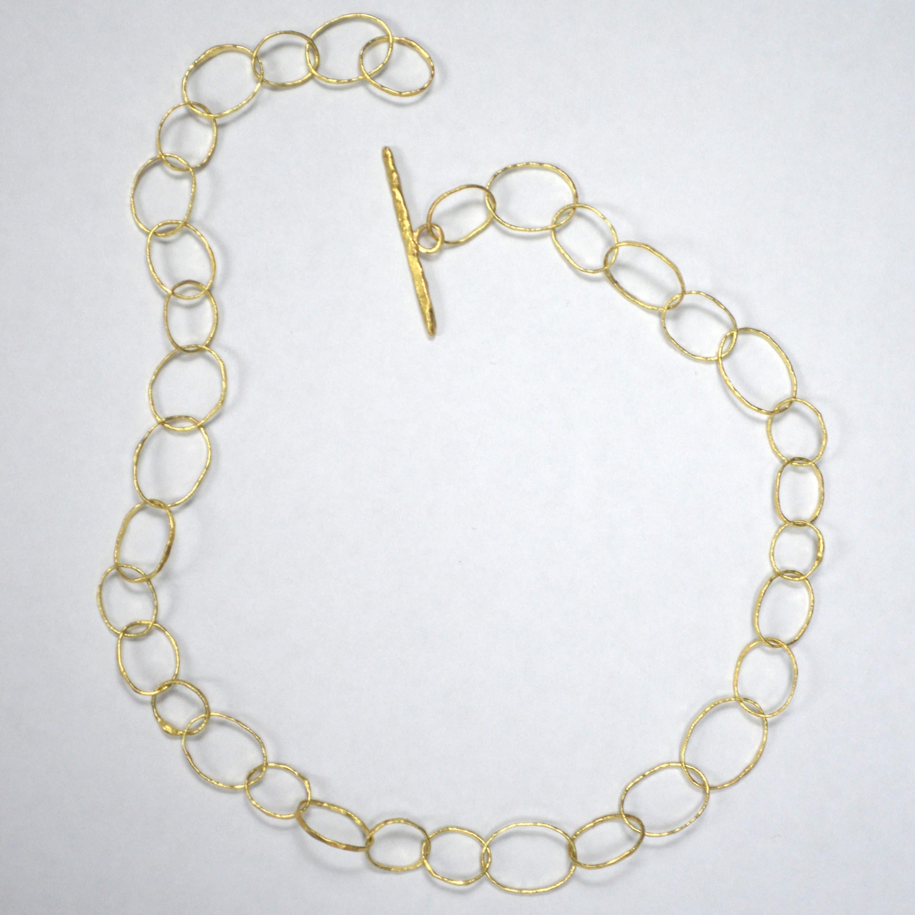 18k yellow gold Necklace handmade by London Goldsmith Disa Allsopp. 

Made from 18k yellow gold, each link on the necklace has been individually formed and hammered to create a warm textured glow. Each link is unique and the varying sizes of each