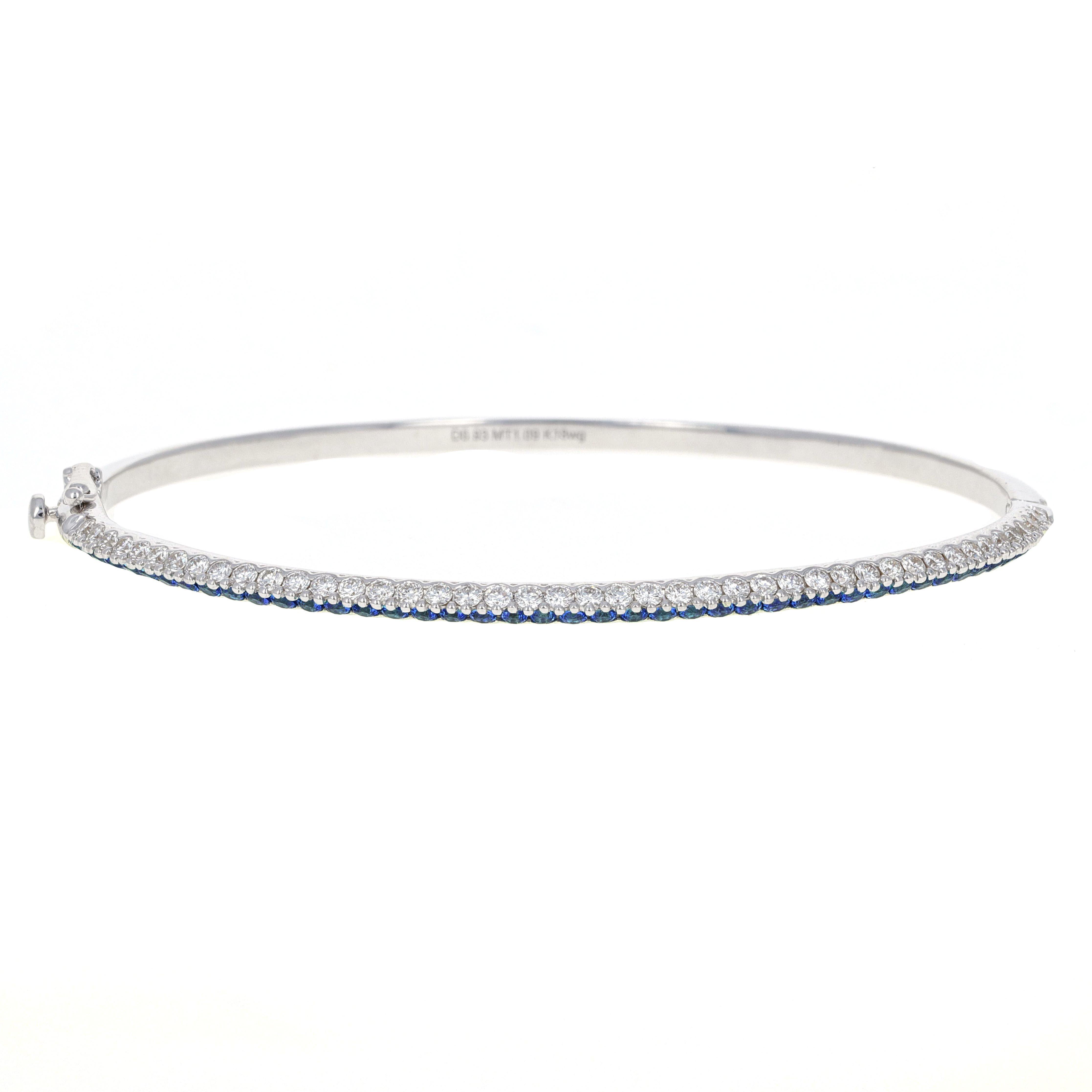 Handmade 18 karat white gold blue sapphire and diamond bangle. The bangle has 44 round brilliant white diamonds weighing a total of 0.93 carats. There is also 44 blue sapphires weighing a total of 1.29 carats total weight.
This bangle is very